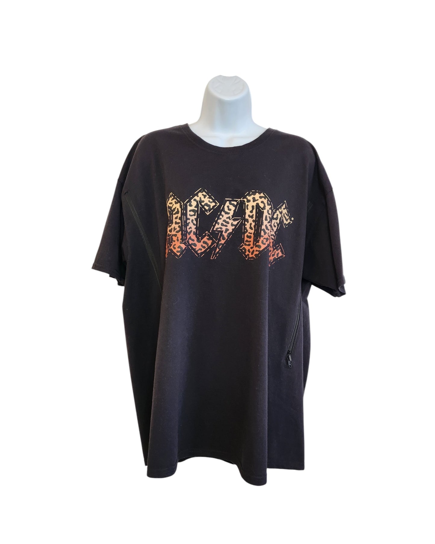 An upcycled 2XL AC/DC band tee for breastfeeding and pumping features a bold leopard print design, blending rock style with practical preloved fashion—ideal for any nursing music fan.