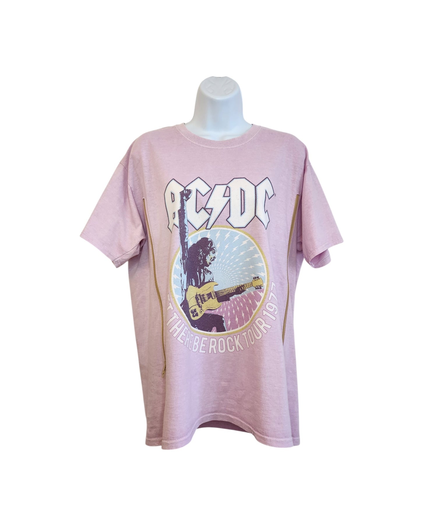 A lilac, upcycled breastfeeding and pumping AC/DC t-shirt (size M) is displayed on a mannequin, featuring the AC/DC logo, a guitarist graphic, and THEIR BE ROCK TOUR 1977 in vintage style.