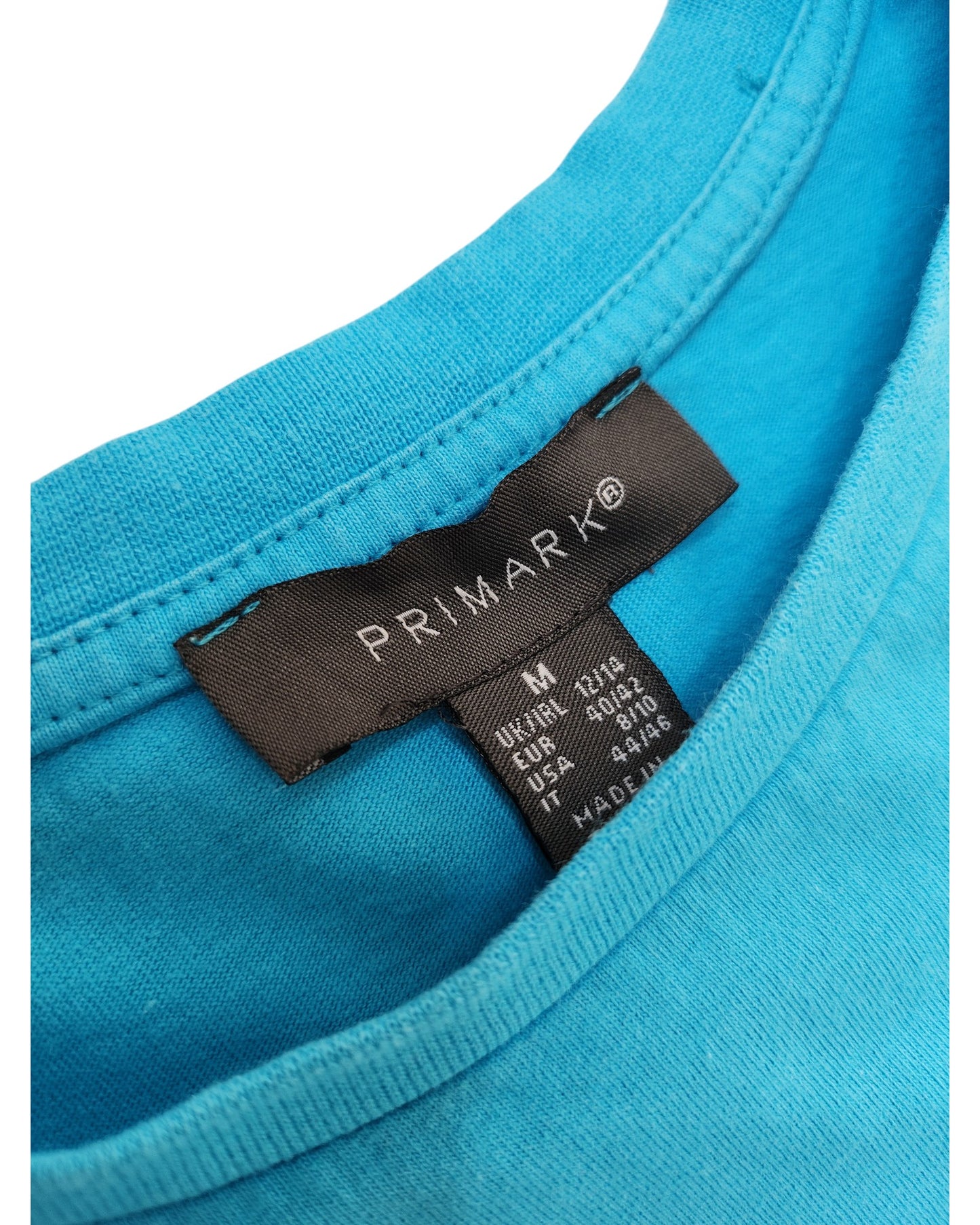 Close-up of a Primark Upcycled Breastfeeding & Pumping Turquoise/Pink Girl t-shirt (M/UK12/14) collar, showing the black label with size and country info—perfect for lovers of preloved nursing wear.