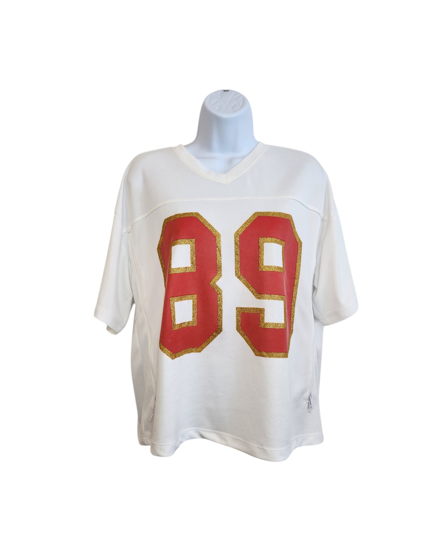 The Messy Bun Just Chillin Upcycled Breastfeeding & Pumping 89 Swiftie Football Jersey t-shirt (size L) features short sleeves and a bold red 89 outlined in gold. Displayed on a mannequin against a white background.