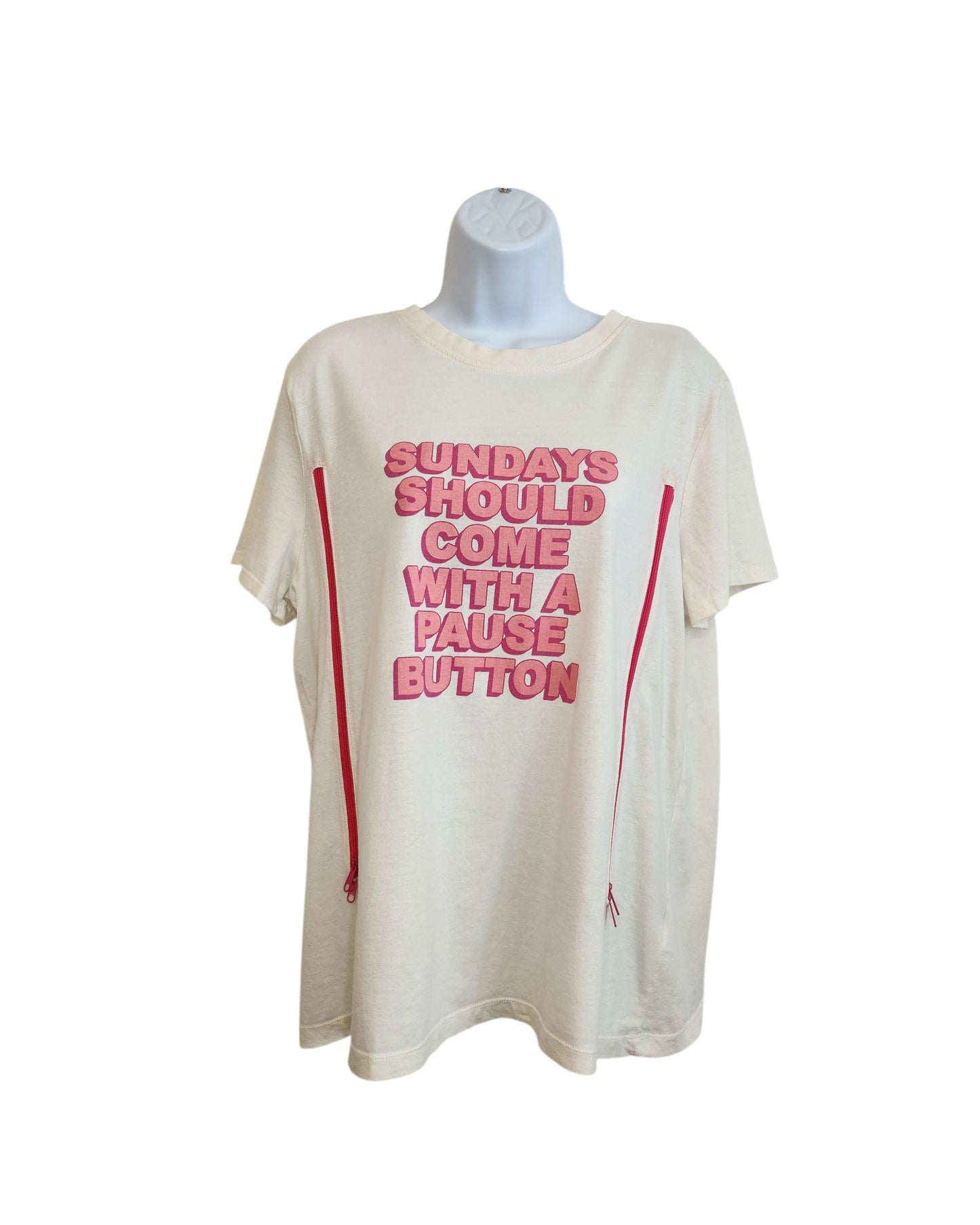 A cream upcycled Primark breastfeeding & pumping t-shirt (L, UK14/16) is displayed on a mannequin, featuring bold pink “SUNDAYS SHOULD COME WITH A PAUSE BUTTON” text and two vertical red lines down the front.