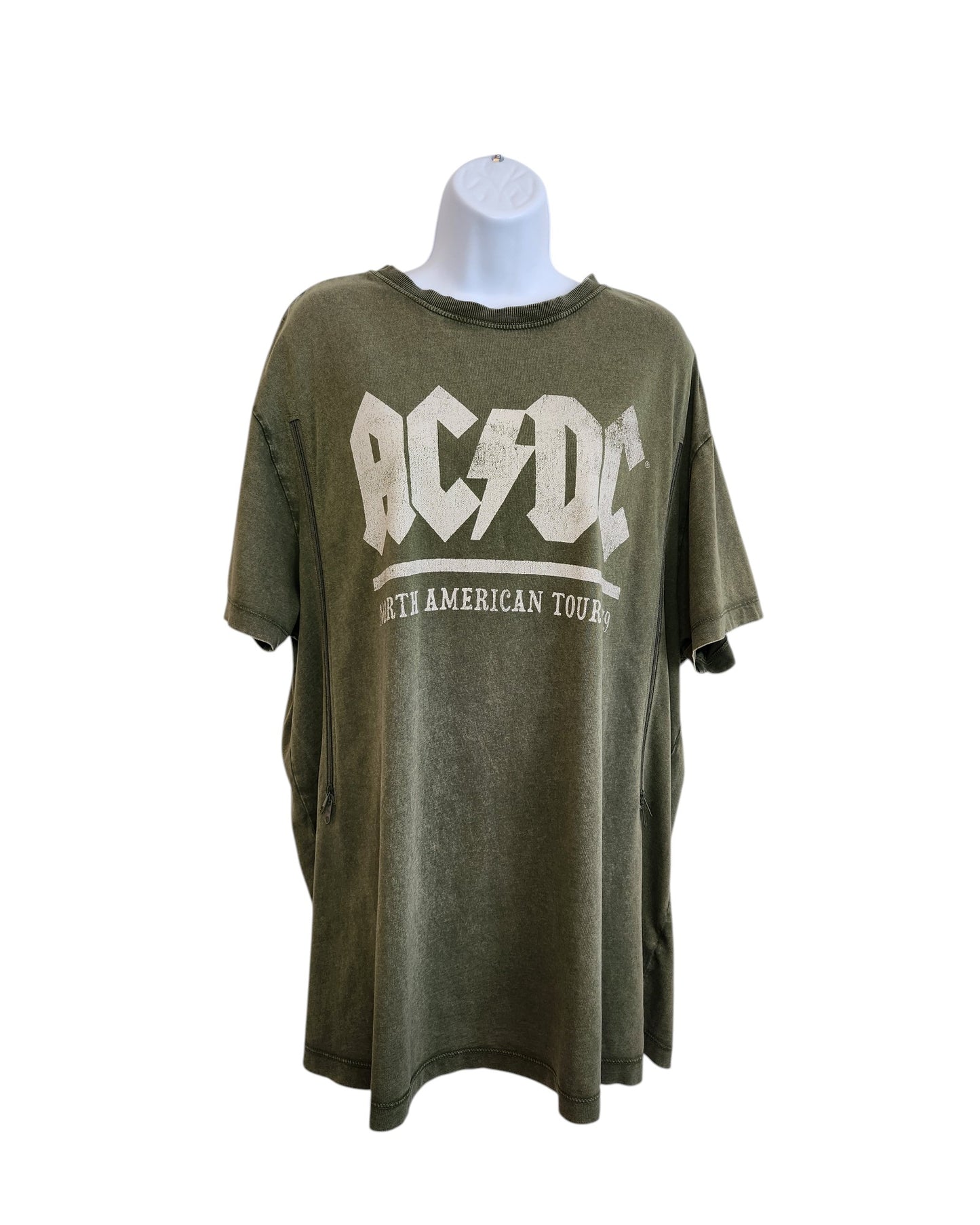A khaki Upcycled Breastfeeding & Pumping AC/DC t-shirt by New Look (UK16), made from eco-friendly materials, displayed on a mannequin and featuring the AC/DC logo and North American Tour in bold white letters on the front.