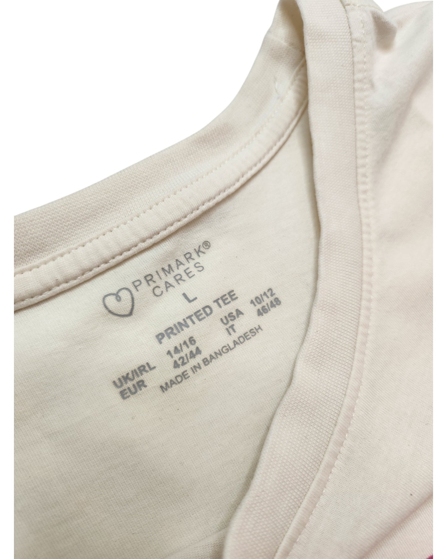 Close-up of a Primark Upcycled Breastfeeding & Pumping Sundays Pause Button t-shirt tag, size L (UK14/16), showing washing instructions and highlighting its eco-friendly, upcycled design, with Made in Bangladesh visible inside the collar.