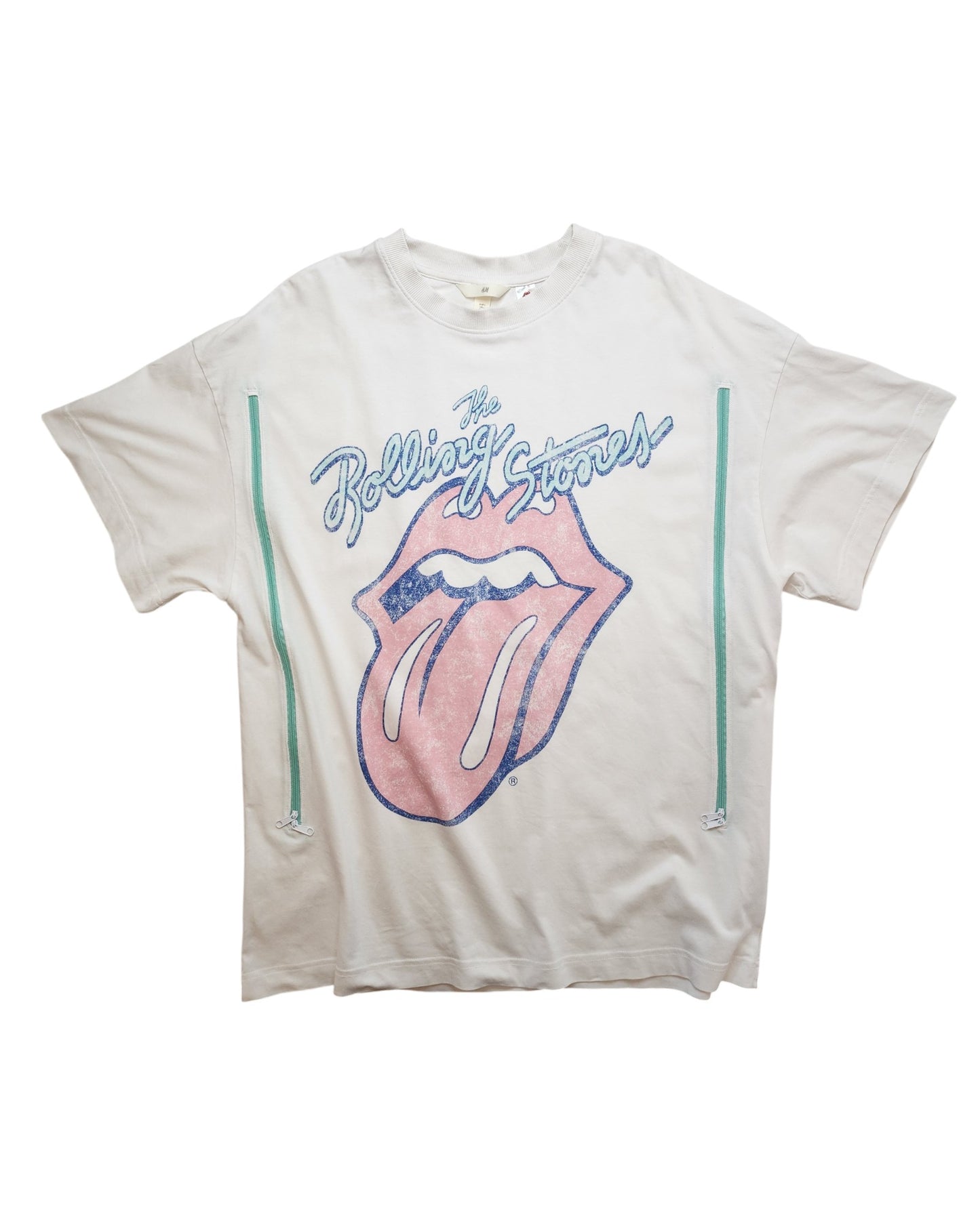 This upcycled H&M Rolling Stones T-shirt in white/blue (size L) features the iconic logo with a pink tongue, blue text, and teal stripes. Designed for breastfeeding and pumping, it adds a unique twist to your wardrobe with preloved fashion flair.