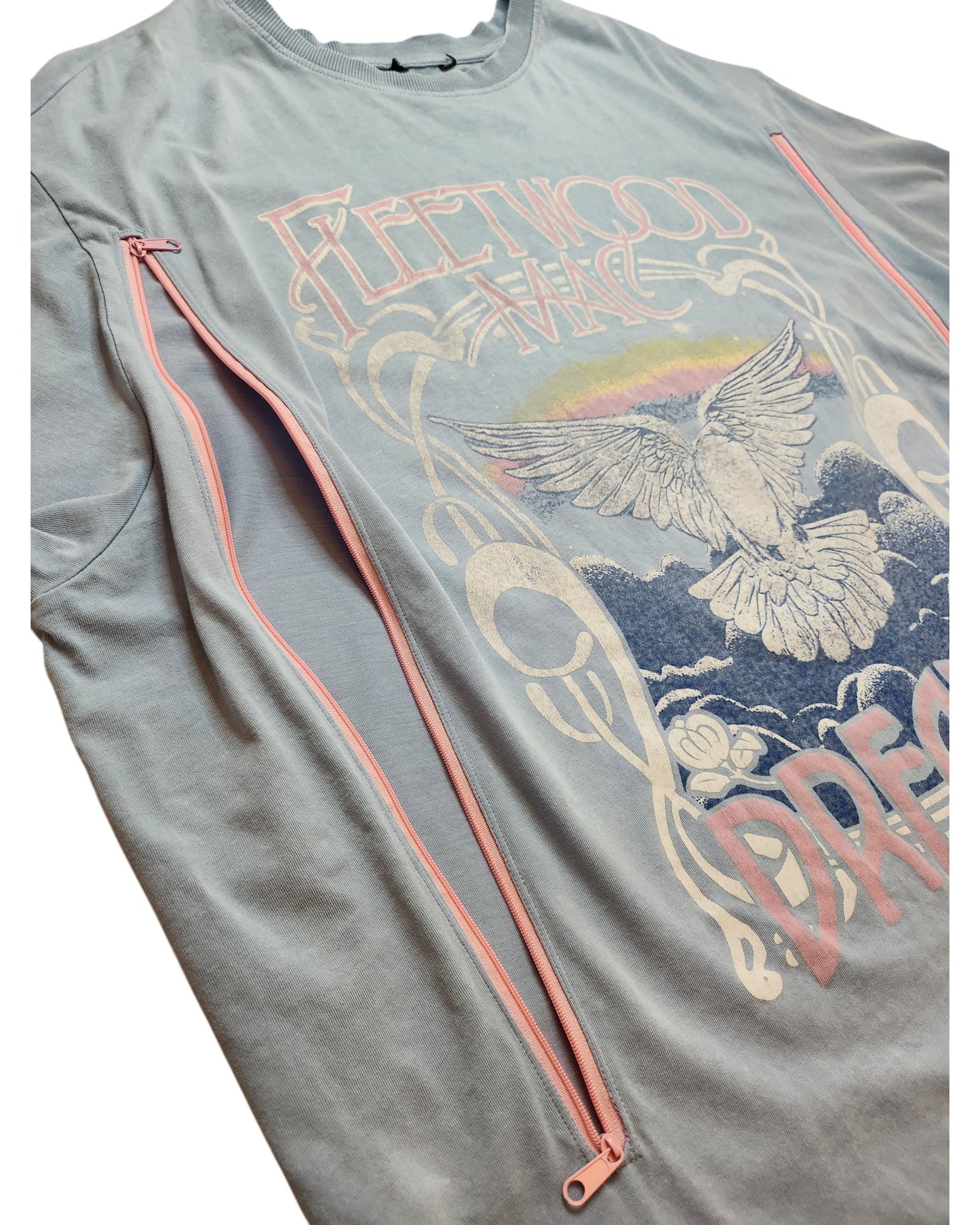 The New Look Upcycled Breastfeeding & Pumping Light Blue Fleetwood Mac Dreams t-shirt (UK18) features a white bird, pastel rainbow graphic, and two pink zippers for easy nursing or pumping—making it a stylish, practical choice.