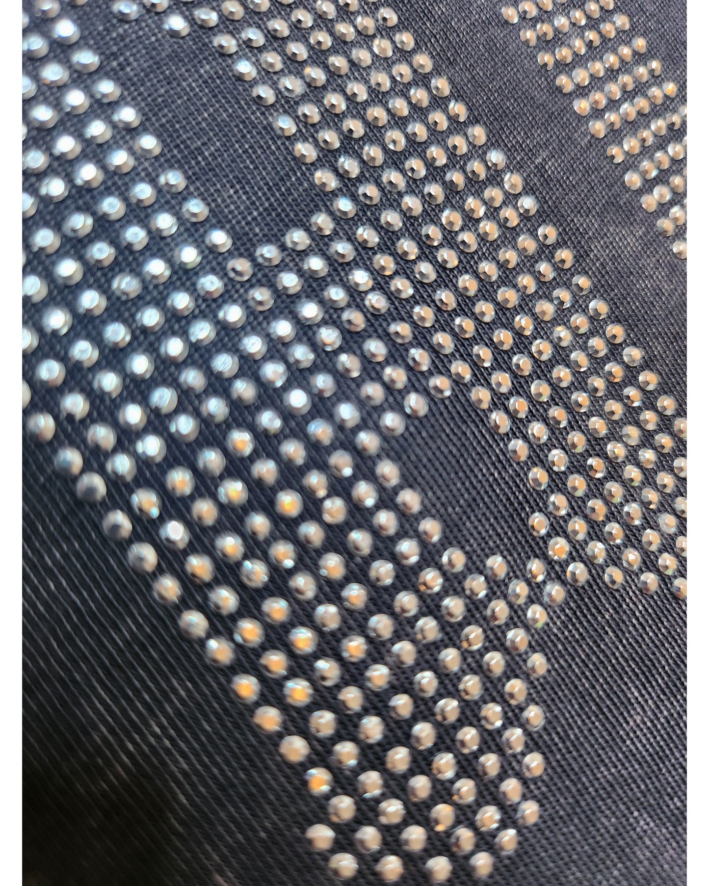 Close-up of metallic diamante studs in a grid pattern on the Upcycled Breastfeeding & Pumping AC/DC Diamante Band t-shirt (UK14) by New Look, highlighting its eco-friendly fashion design.
