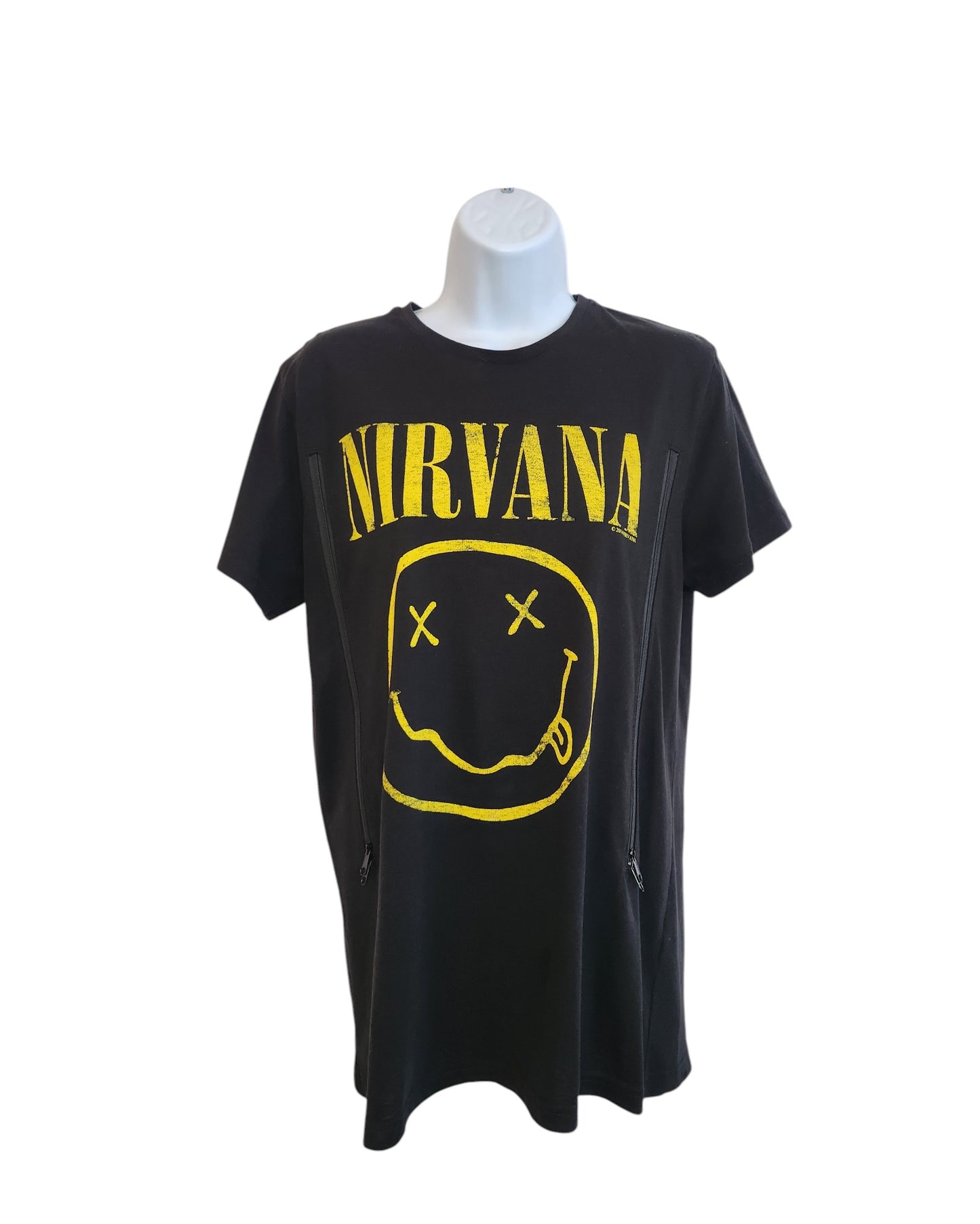 The Cedar Wood State Upcycled Breastfeeding & Pumping Black Yellow Smile Nirvana Band t-shirt (size M) features bold yellow NIRVANA lettering and a smiley face logo with crossed-out eyes, displayed on a mannequin.