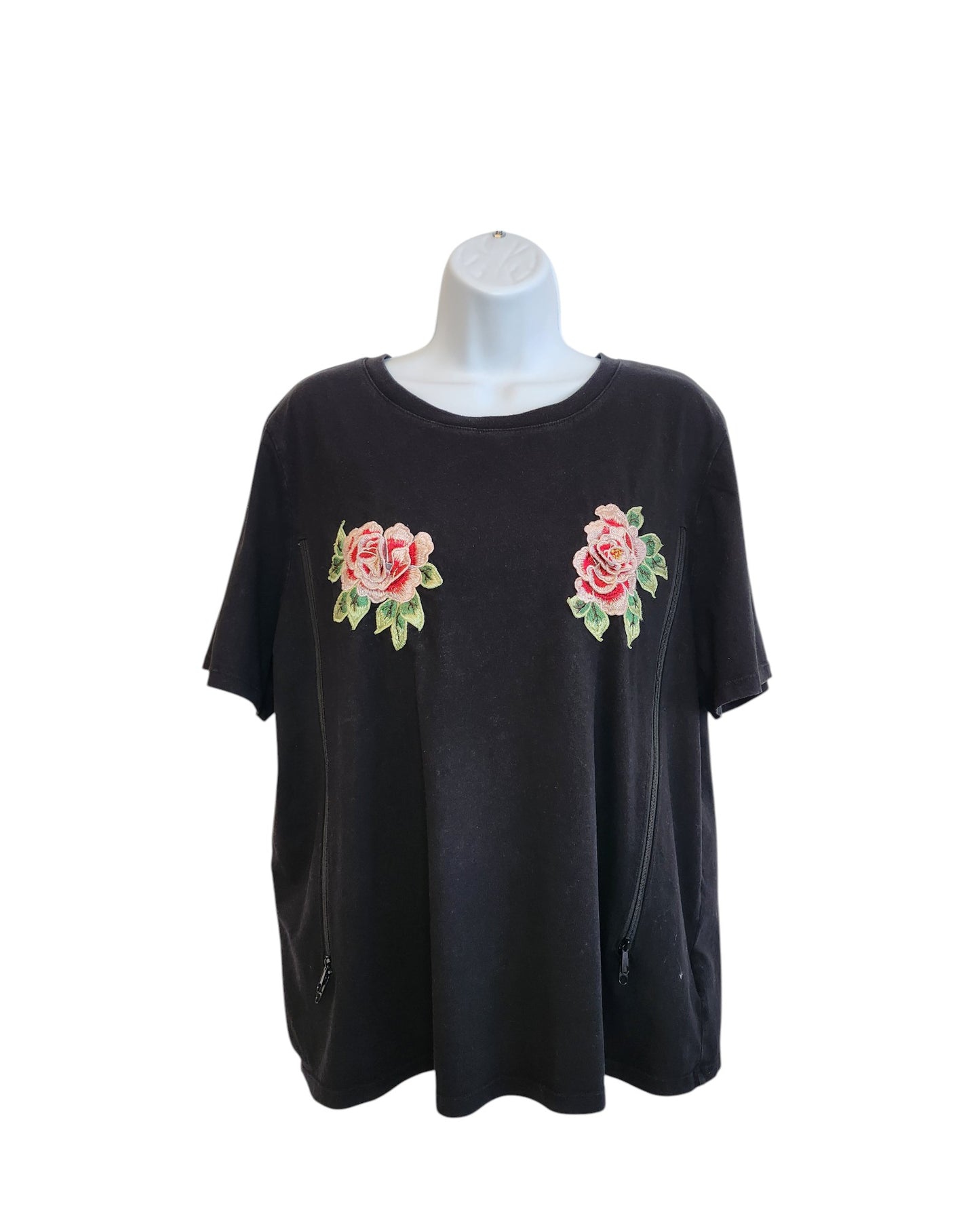 An upcycled H&M black short-sleeve t-shirt (size L) for breastfeeding and pumping, featuring pink floral embroidery and two front zippers—perfect for fans of unique preloved fashion. Shown on a mannequin with a plain white background.