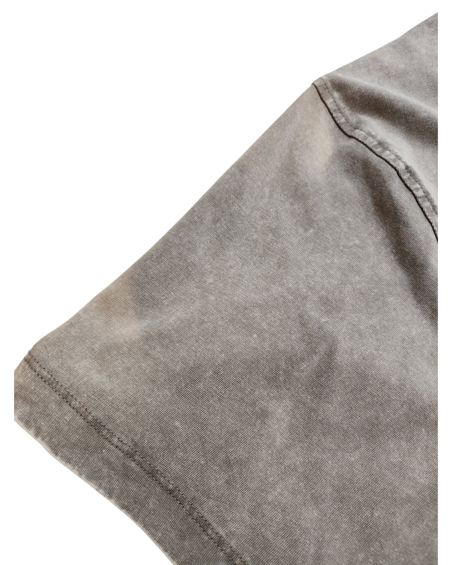 Close-up of a Primark Upcycled Breastfeeding & Pumping Beige/Grey Nirvana Band t-shirt (L), highlighting the faded sleeve hem and side seam—an eco-friendly choice for nursing moms.