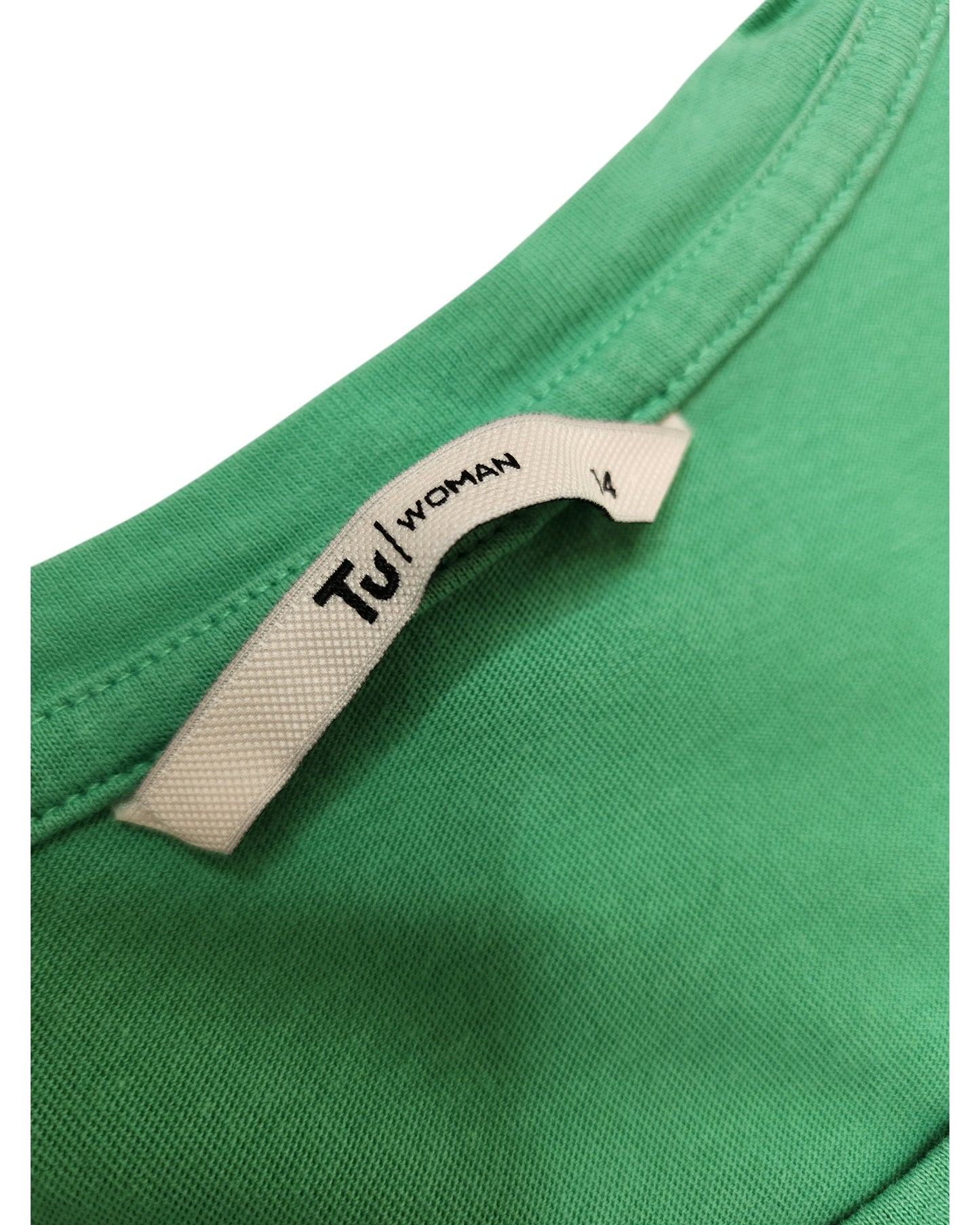 Close-up of an upcycled green Tu t-shirt, size UK14, with a white fabric label reading Tu sewn into the neckline. Designed for breastfeeding and pumping away from your desk.