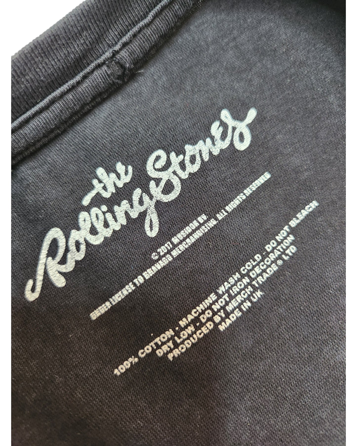 Close-up of a black Boohoo Upcycled Breastfeeding & Pumping The Rolling Stones Band t-shirt dress (UK8) label, showing white logo, care instructions, fabric details, and eco credentials promoting preloved clothing.