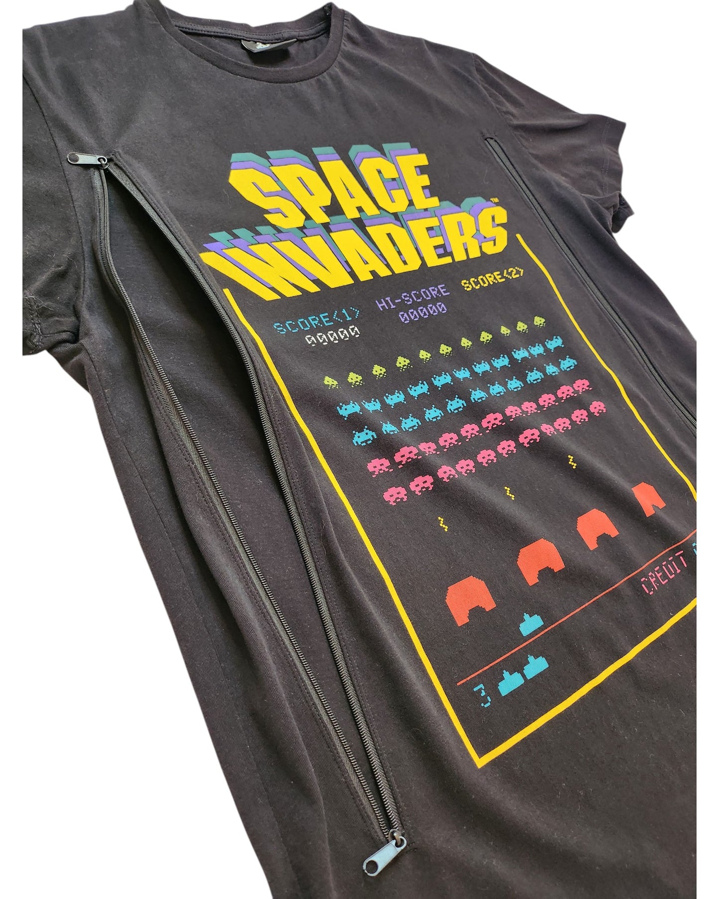 The Cedar Wood State Upcycled Breastfeeding & Pumping Space Invaders t-shirt (M) is a black tee with a colorful arcade alien design, two vertical zippers for nursing or pumping, and classic game scores—stylish and functional.