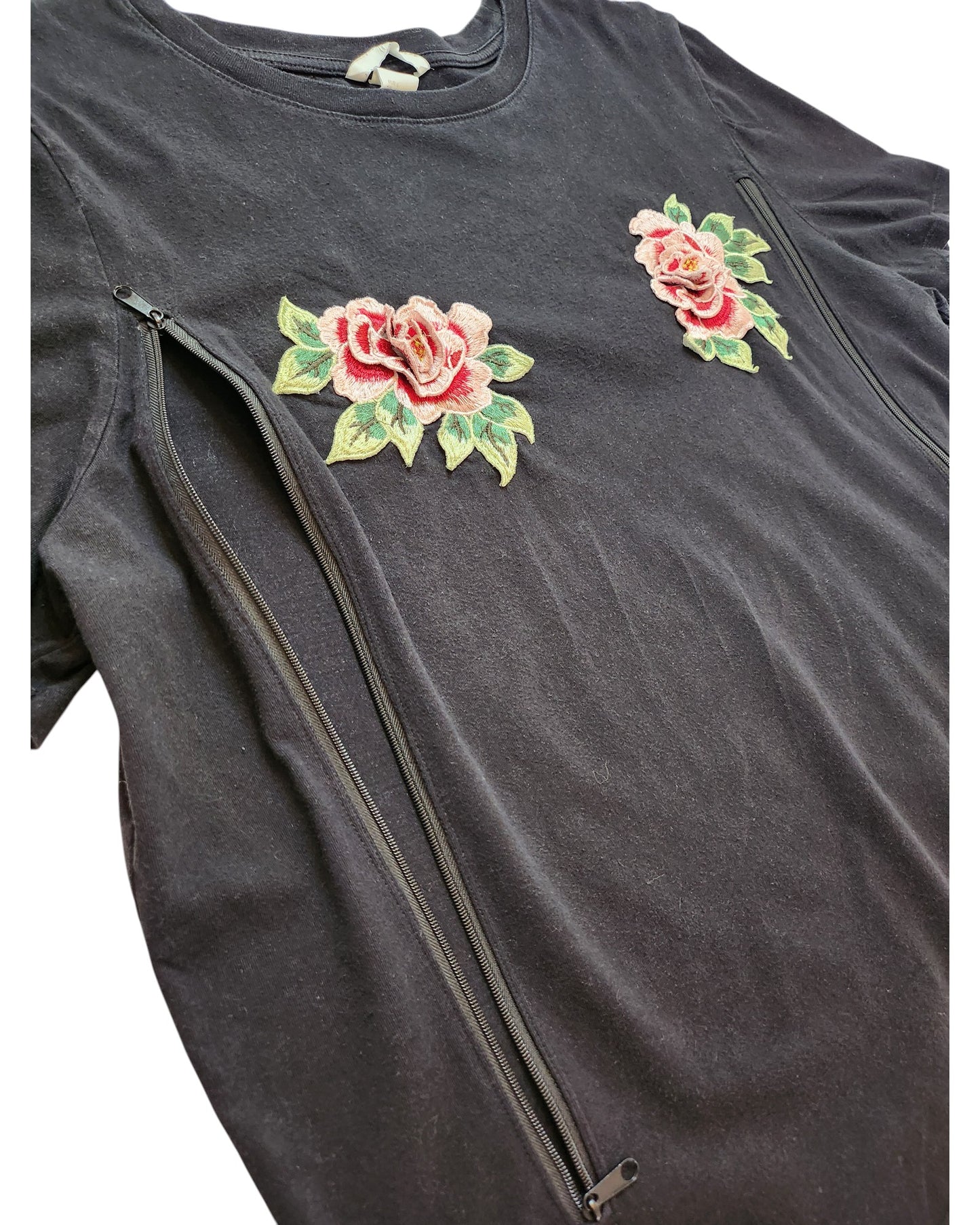 The H&M Upcycled Breastfeeding & Pumping Black Floral Embroidered Flowers t-shirt L features pink and green roses on the chest with side zippers, offering a stylish and practical option for nursing moms.