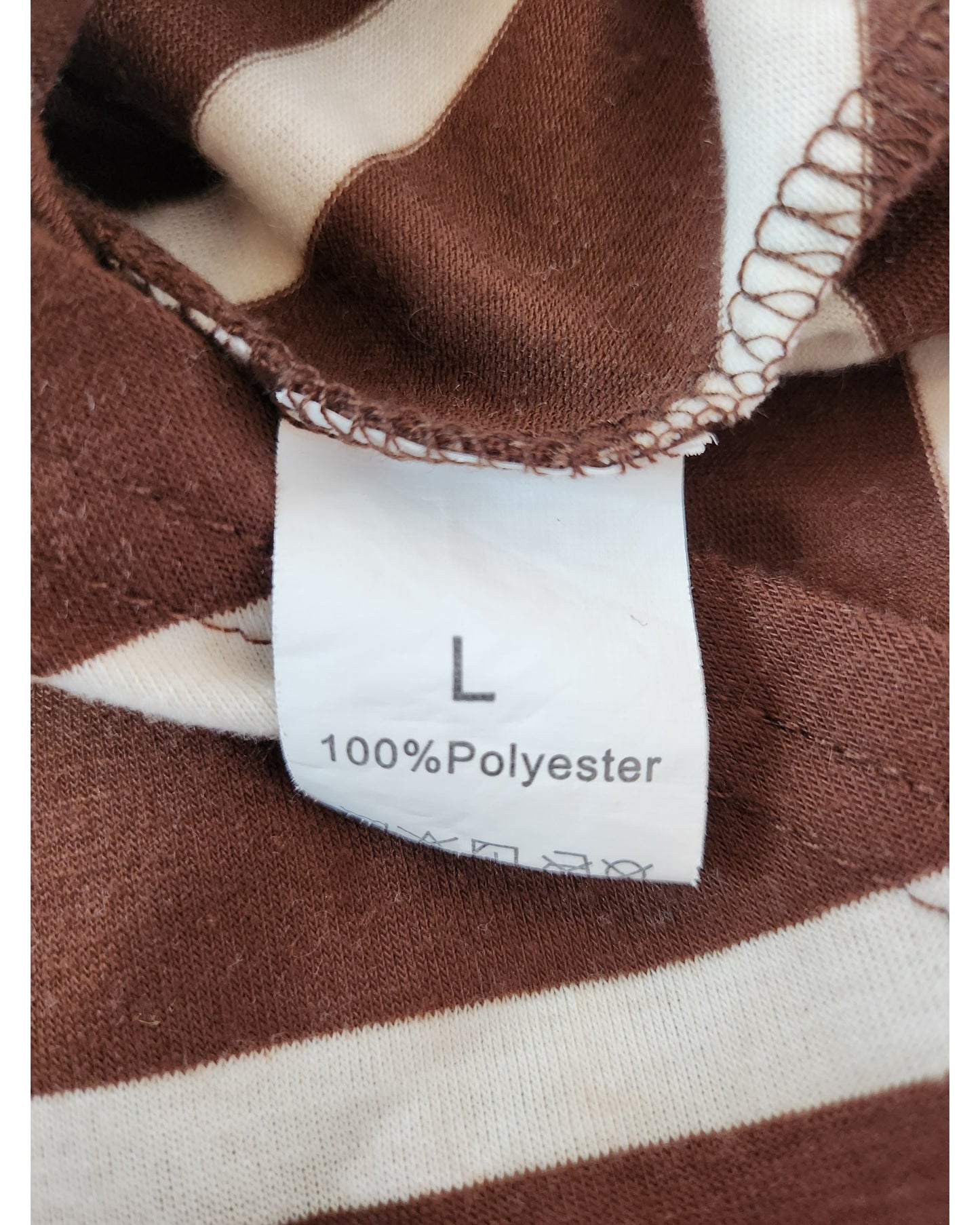 A close-up of the TikTok Upcycled Breastfeeding & Pumping Brown/Cream Stripe Dress label (L, 100% Polyester) shows care symbols below—perfect for those who value sustainable fashion.