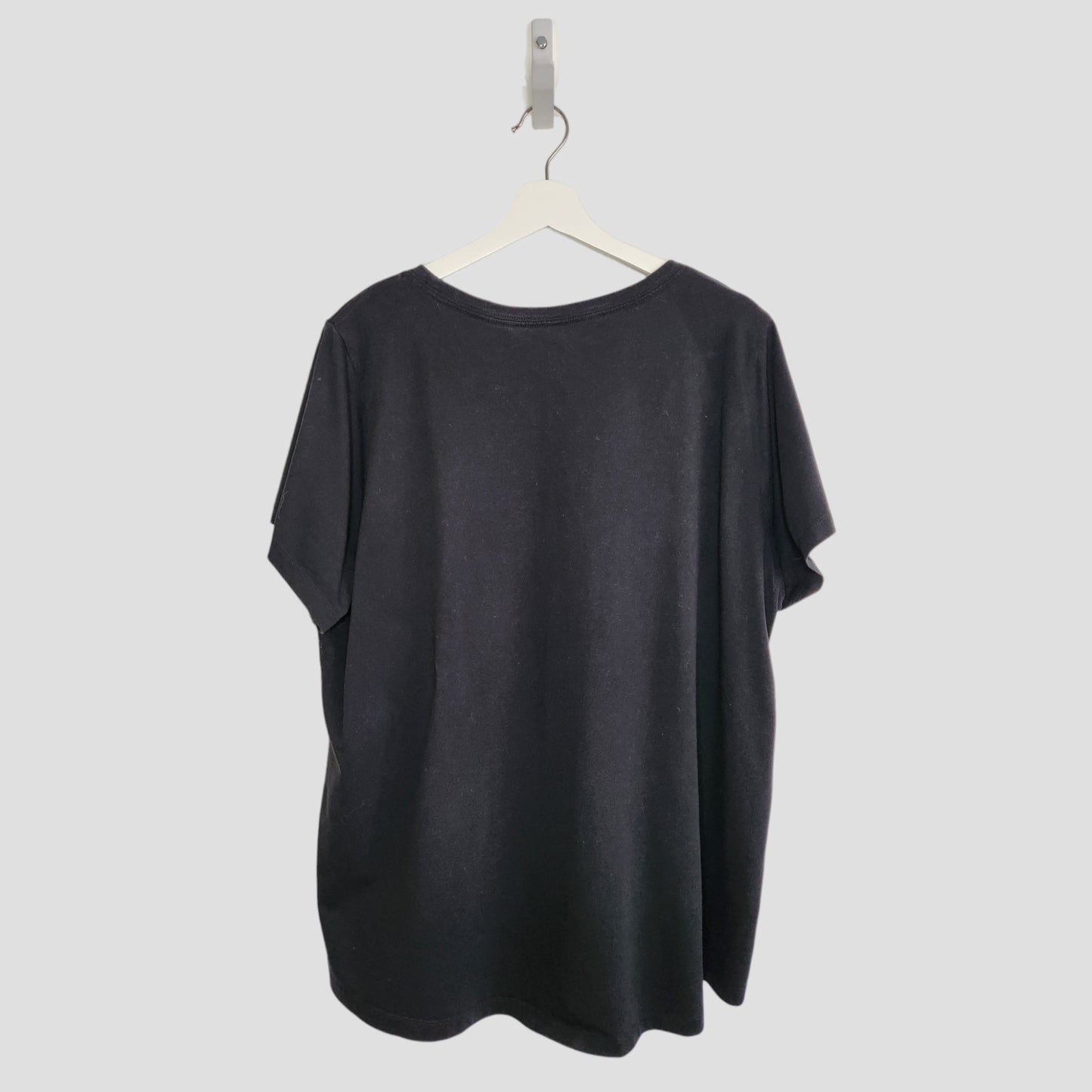 The Upcycled Breastfeeding & Pumping Black/White Nike t-shirt (XXL) is displayed on a white hanger against a light gray background, shown from the back—ideal for preloved clothing collections.