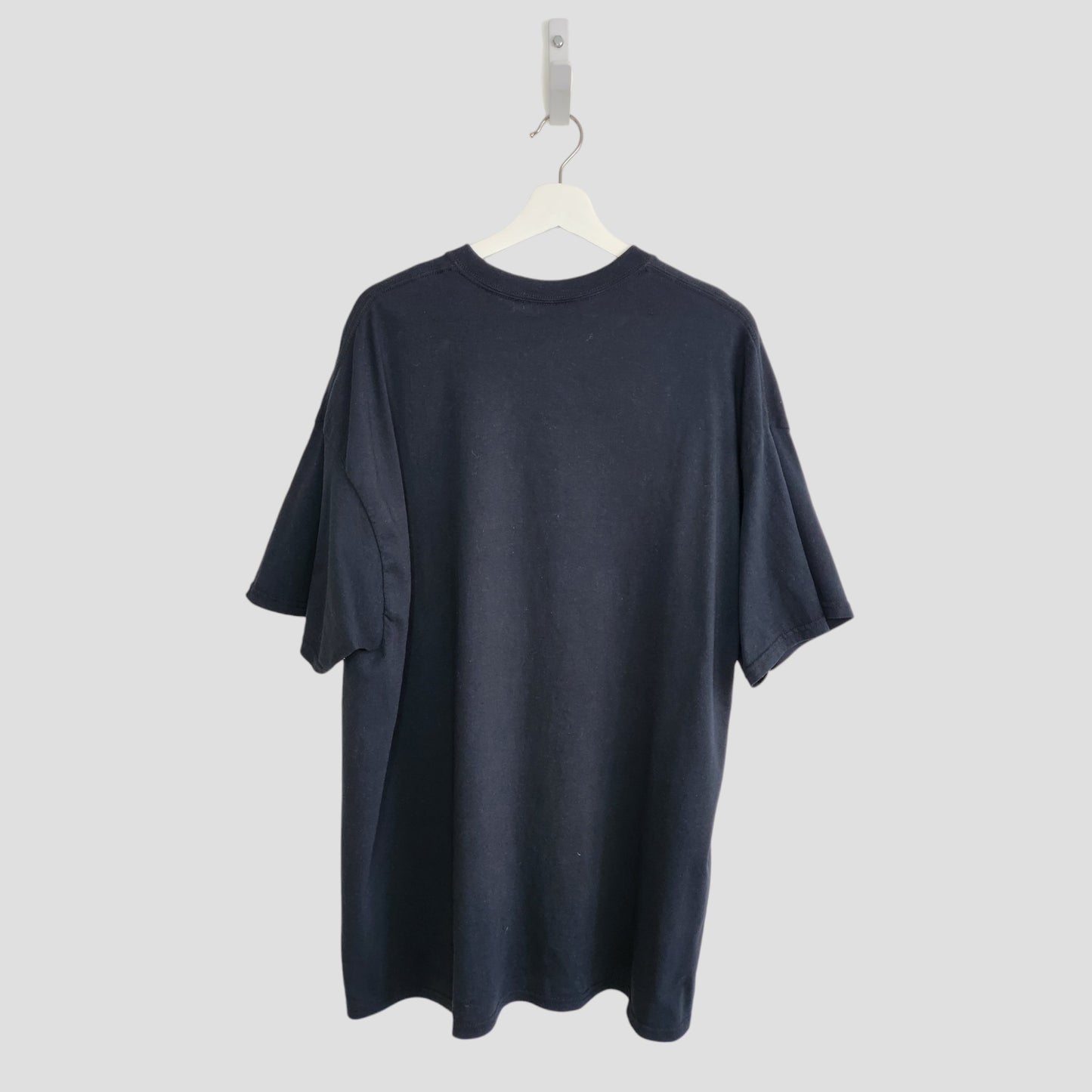 The GNR Upcycled Breastfeeding & Pumping Black Cross Guns N’ Roses t-shirt (XXL) hangs on a white hanger, shown from the back against a light gray background.