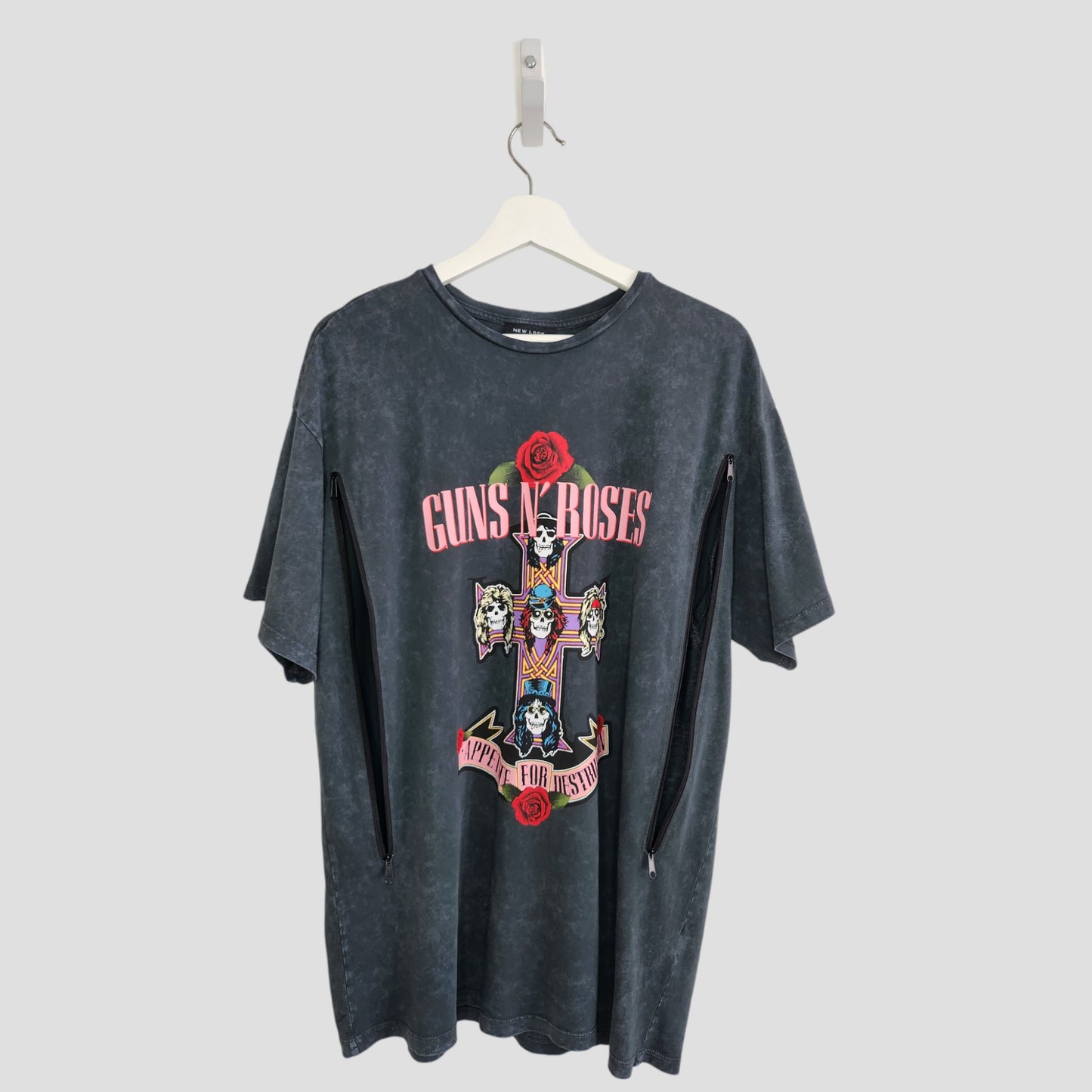 A grey Guns N’ Roses band T-shirt by New Look, upcycled for breastfeeding and pumping (UK14), features a cross with roses—a sustainable fashion choice crafted from preloved clothing.
