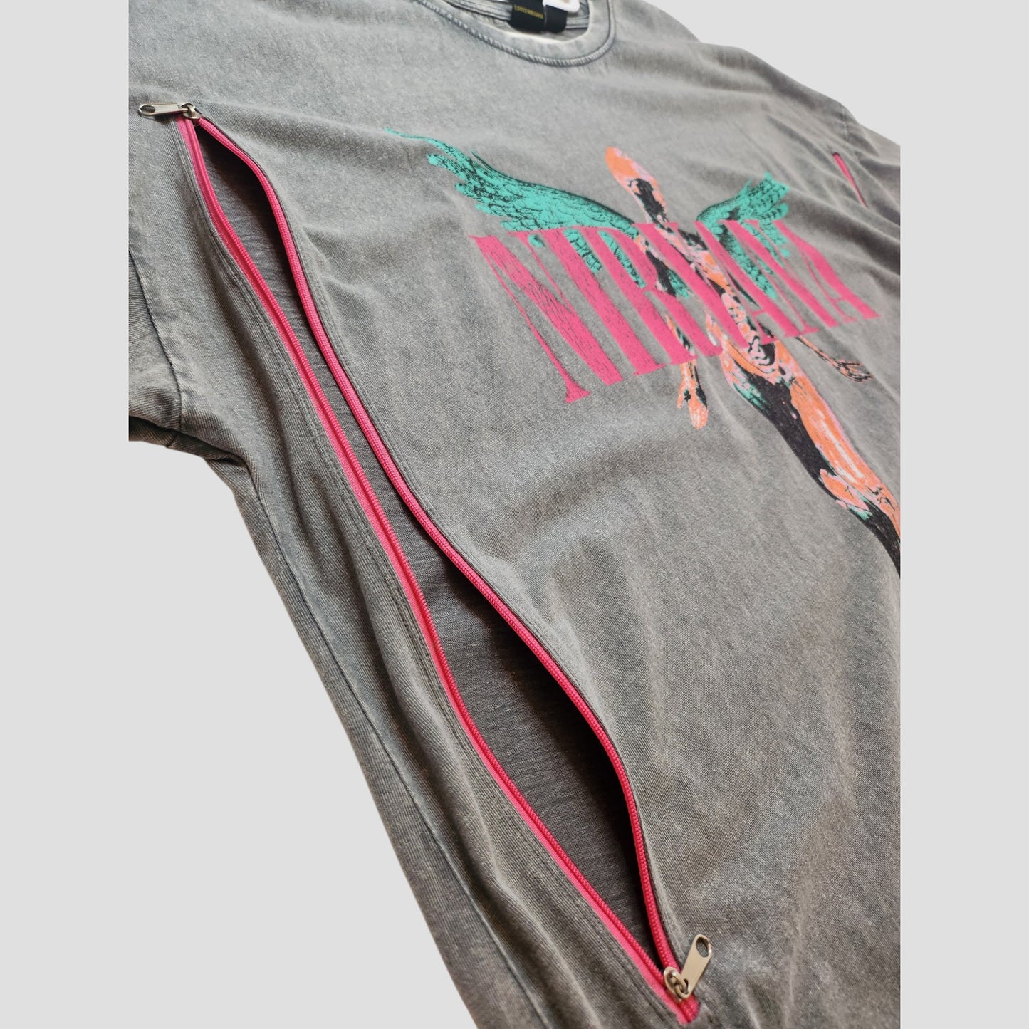 The Primark Upcycled Breastfeeding & Pumping Grey/Pink Nirvana Angel t-shirt dress (L, UK14/16) features a graphic design and a red diagonal zipper with pink lining—ideal eco-friendly nursing wear.