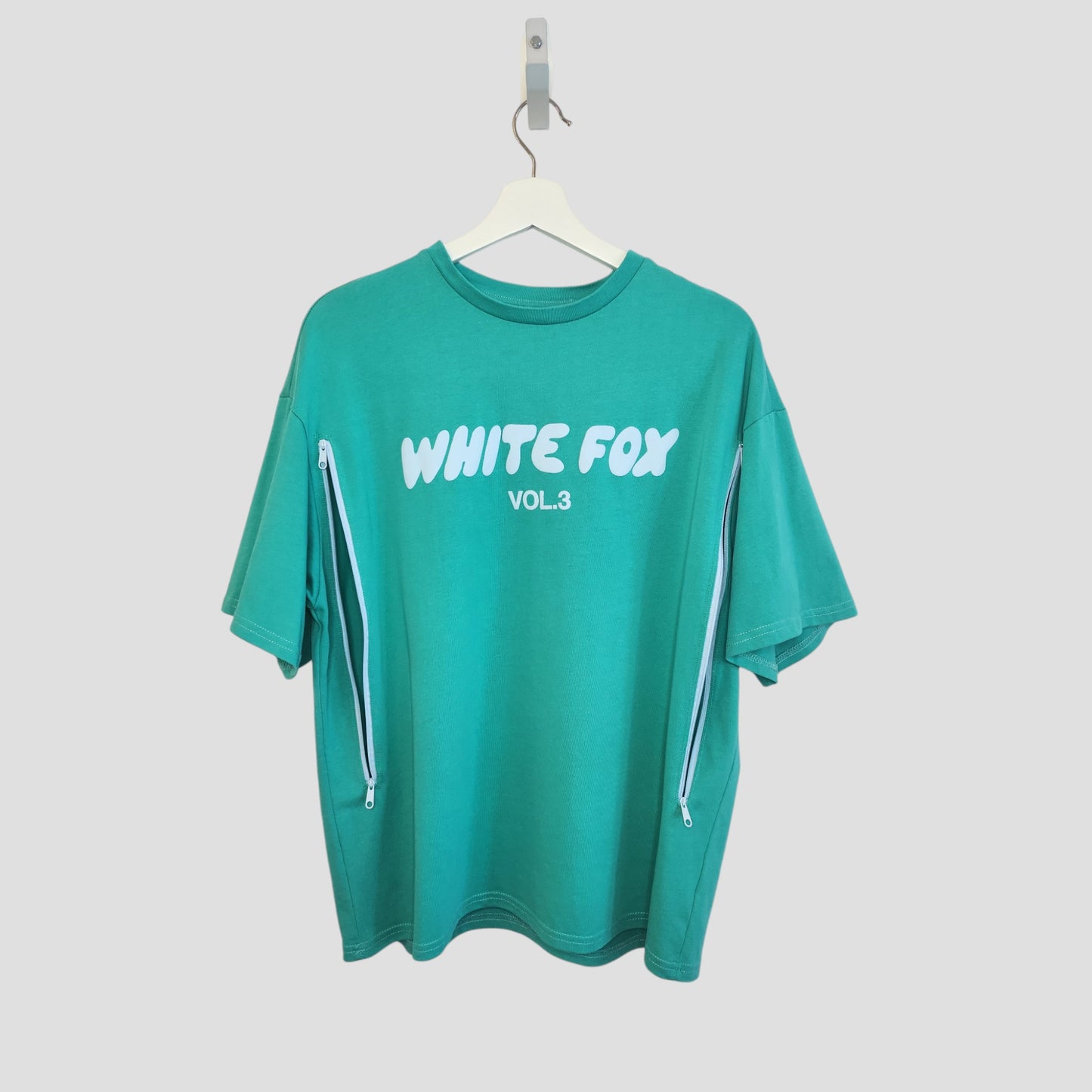 Upcycled Breastfeeding & Pumping Green White Fox t-shirt (size M, 100266) with WHITE FOX VOL.3 in white text on the front and white zippers down both sleeves; ideal for nursing or pumping moms seeking stylish comfort.