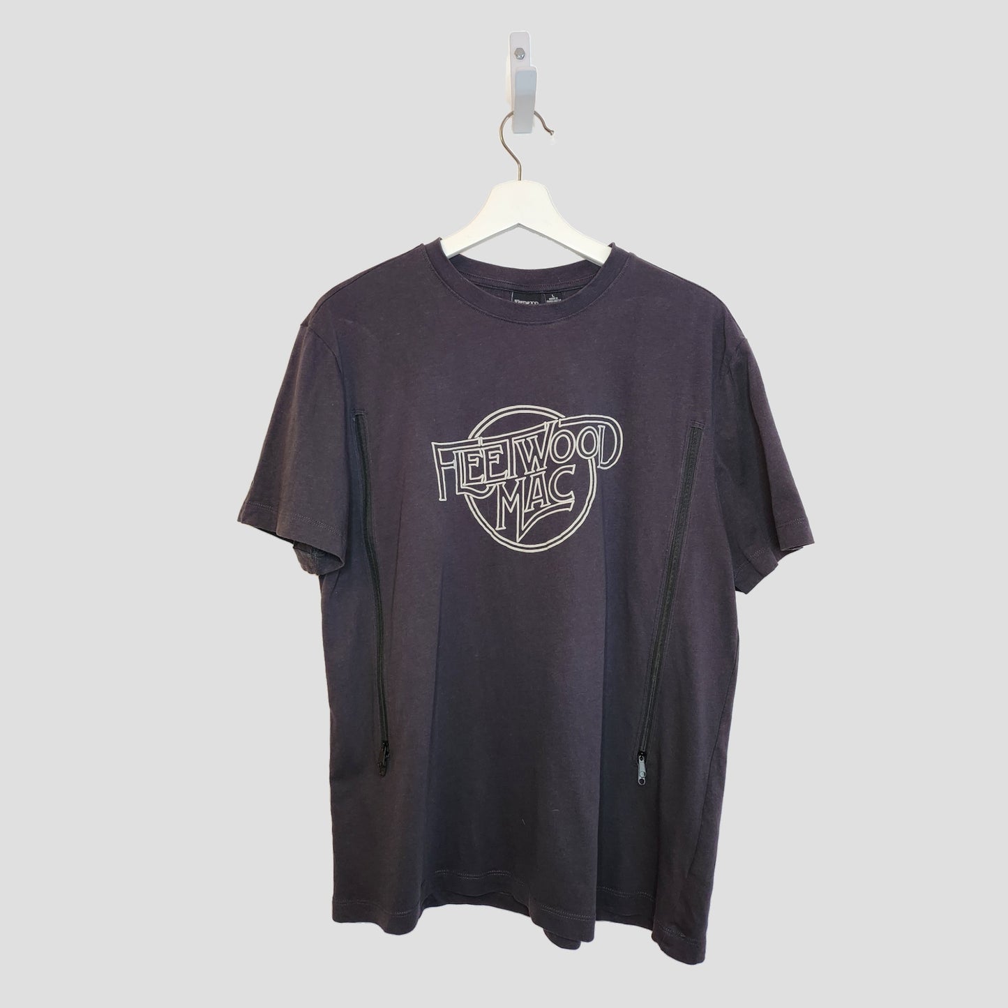 A Primark Upcycled Breastfeeding & Pumping Fleetwood Mac black/white T-shirt (L, UK14/16, 100292) hangs on a white hanger against a plain light background.