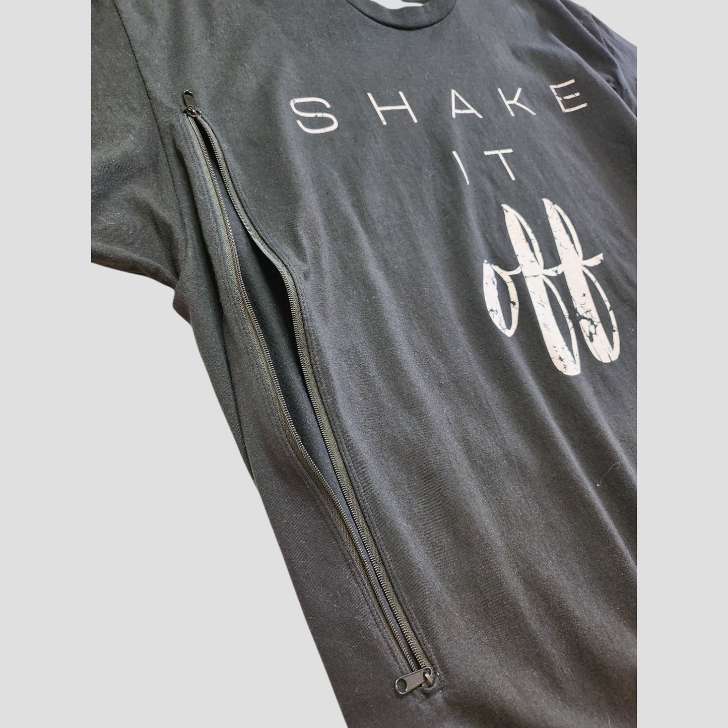 The Port & Company Upcycled Breastfeeding & Pumping Black Shake It Off t-shirt XL (100298) features white lettering and a long diagonal zipper for style and convenient nursing access.