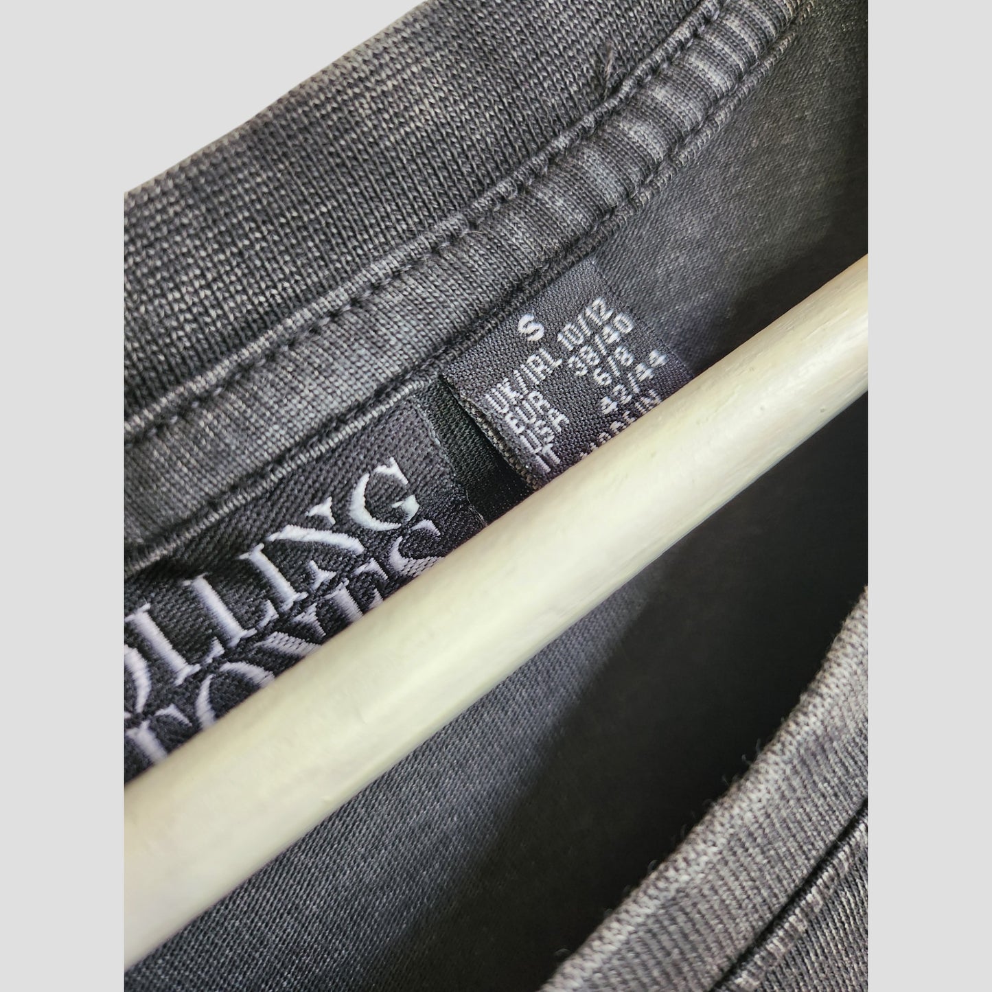 Close-up of a gray Primark Upcycled Breastfeeding & Pumping Rolling Stones Band oversized T-shirt dress (Size S/UK10/12), showing care tag and inner label—perfect for those seeking eco-friendly nursing clothes.