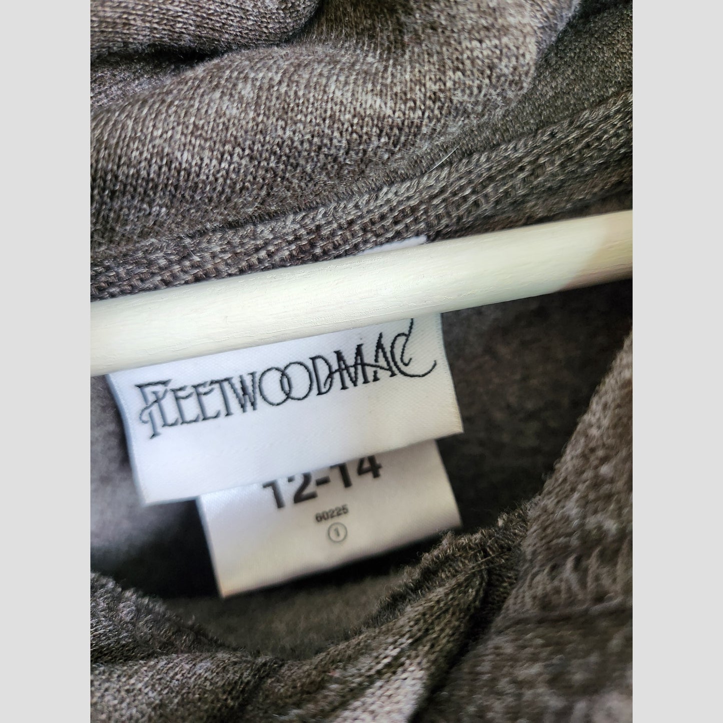 A close-up shows a label reading Fleetwood Mac on a preloved upcycled grey breastfeeding & pumping band hoodie (UK12/14), with the size tag visible on gray fabric and displayed on a white hanger.