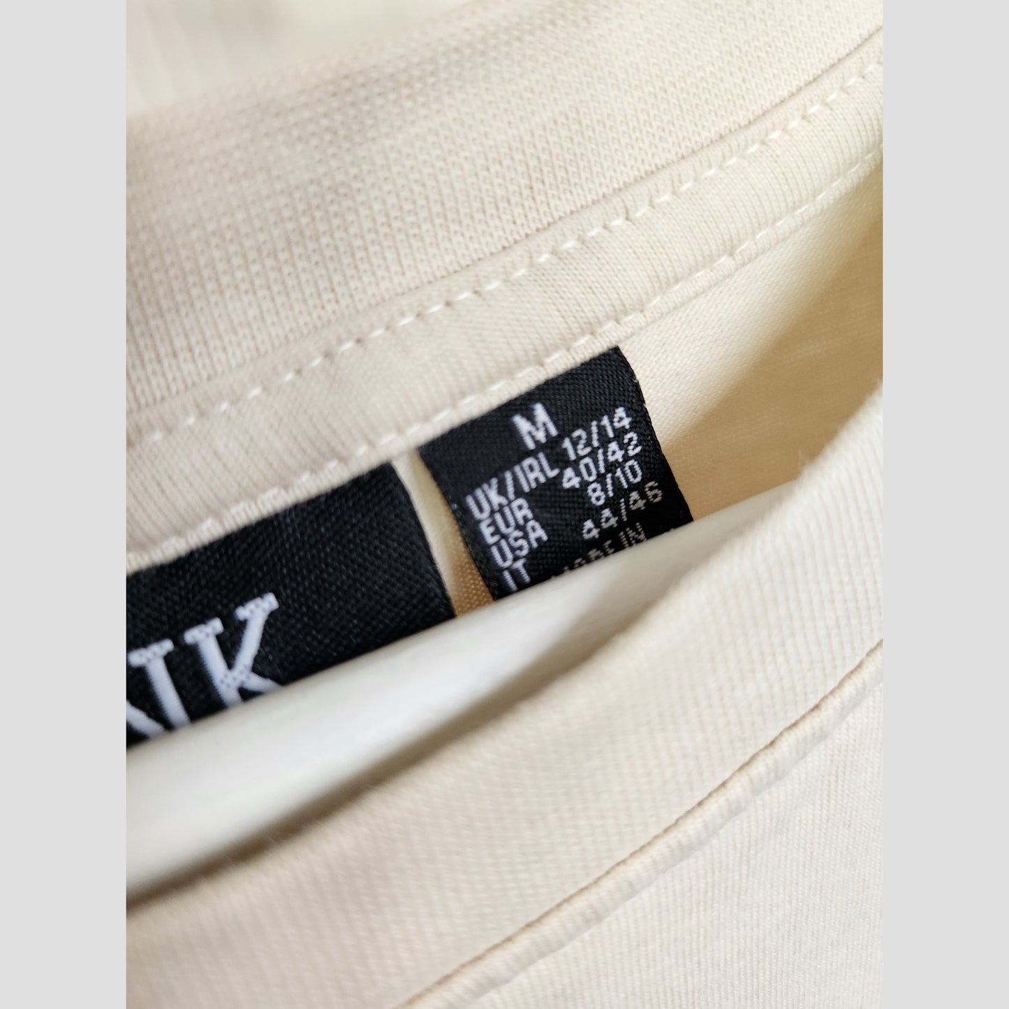 A close-up shows a Primark Upcycled Breastfeeding & Pumping Cream Pink Floyd Band t-shirt (M, UK12/14) with a black size tag displaying: UK/IRL 12/14, EU 40/42, USA 8/10, IT 44/46, and M for medium.