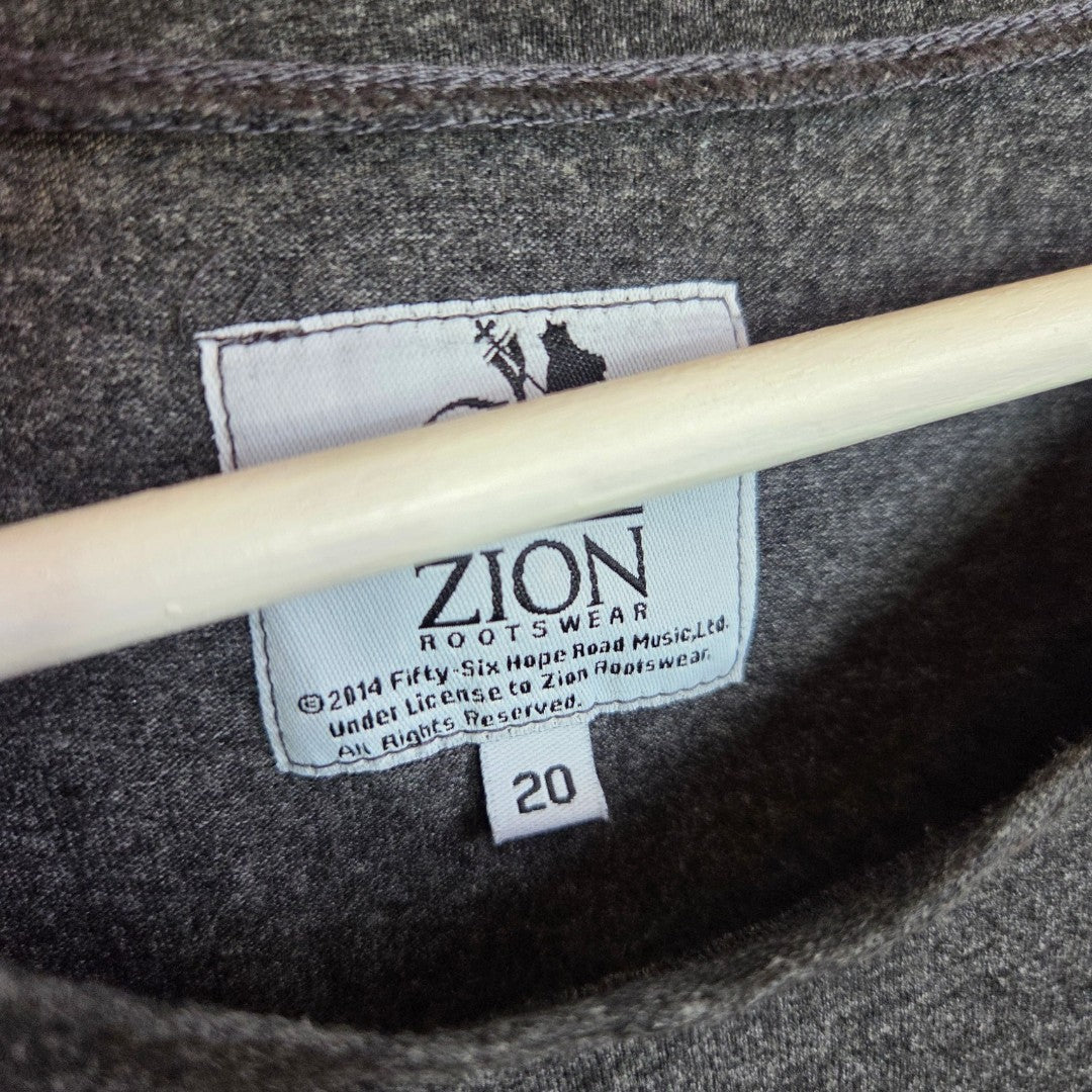 A close-up shows the label inside a gray Primark Upcycled Breastfeeding & Pumping Bob Marley Band t-shirt UK20 (100426), with copyright info printed below. The label is sewn onto the fabric, and a hanger is visible.