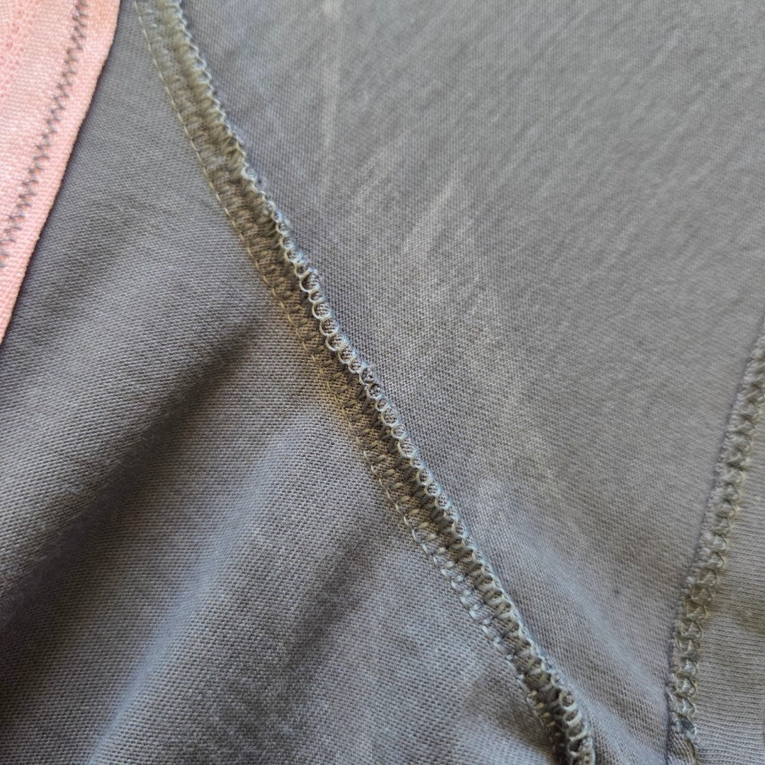 Close-up of grey and purple fabric with visible stitching and seam detail on the George Upcycled Breastfeeding & Pumping The Doors Band t-shirt (UK18), highlighting stylish texture for eco-friendly nursing wear.