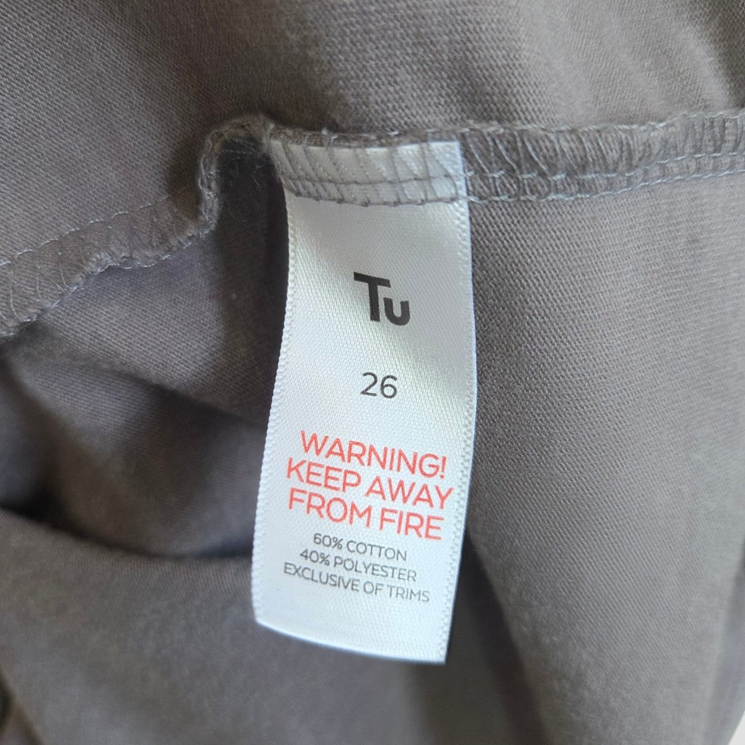 A label for Tu's Upcycled Breastfeeding & Pumping Grey Pastel Bowie Band t-shirt UK26 warns in red: WARNING! KEEP AWAY FROM FIRE. Fabric is 60% cotton, 40% polyester, exclusive of trims.