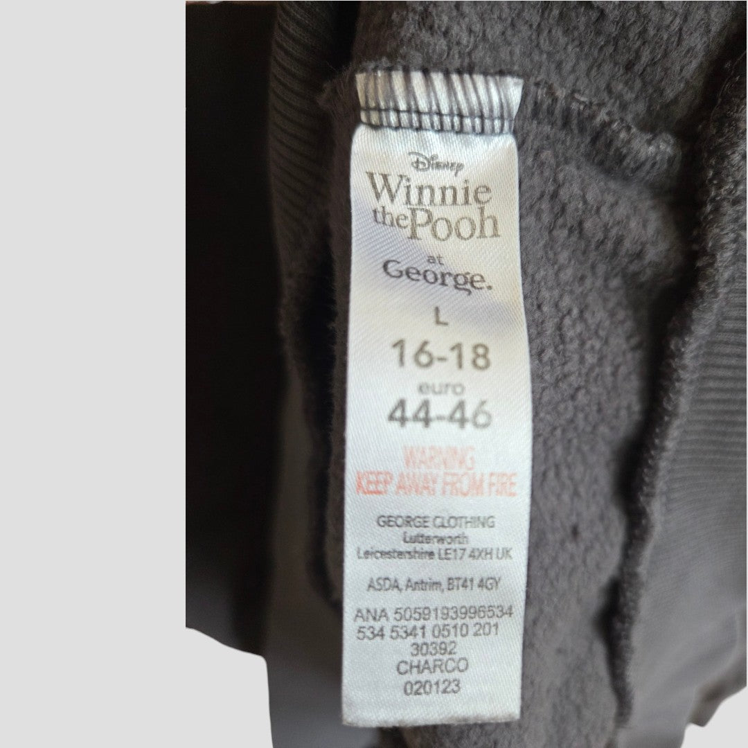 Clothing tag reads George Upcycled Breastfeeding (Nursing) & Pumping Grey Winnie the Pooh Bother sweatshirt, size L (UK 16-18, euro 44-46). Warning: keep away from fire. Manufacturer and product info are also visible below, making it a practical choice for those seeking affordable maternity wear.
