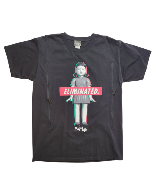 The touched out mama Upcycled Breastfeeding & Pumping Squid Games T-shirt features a cartoon doll with a retro 3D effect and ELIMINATED in bold red, accompanied by Korean characters for flair.