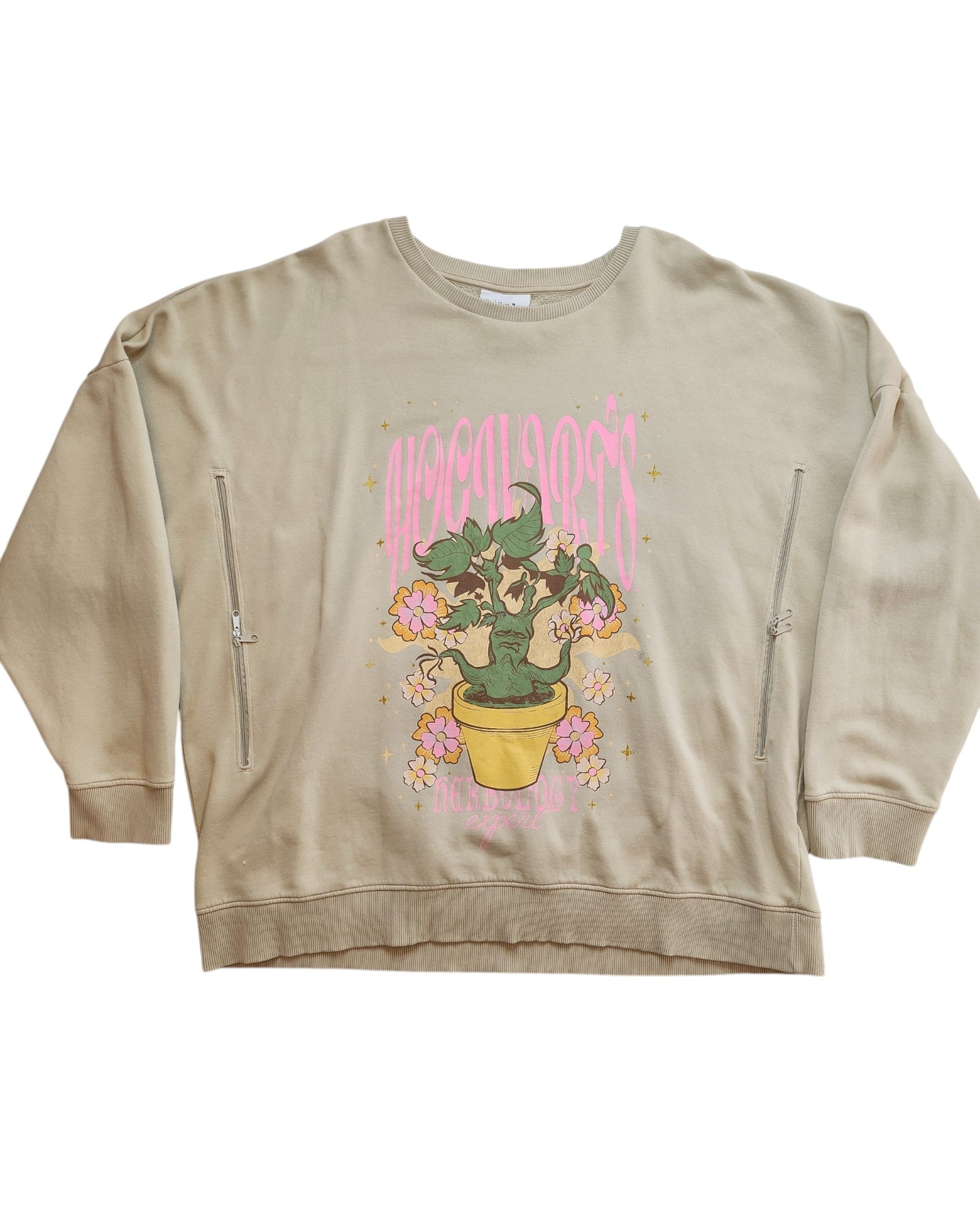 The Upcycled Breastfeeding & Pumping Harry Potter Sweatshirt 2XL from touched out mama is a beige top with a potted green plant and pink flowers, encircled by the word Apocalypse in pink text and star accents. Made from preloved clothing, it includes two zippers for easy nursing access.
