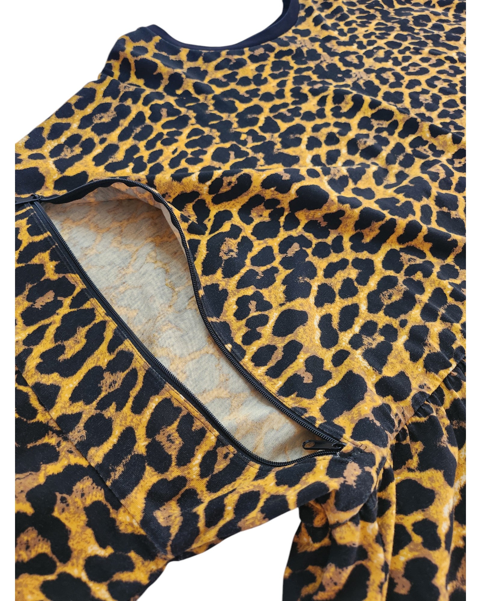 The preloved Upcycled Breastfeeding & Pumping Cheetah T-shirt by touched out mama in UK30 features an unzipped section revealing its inner lining. Dark, irregular spots contrast with a vibrant yellow-orange background, adding unique charm to this distinctive piece.