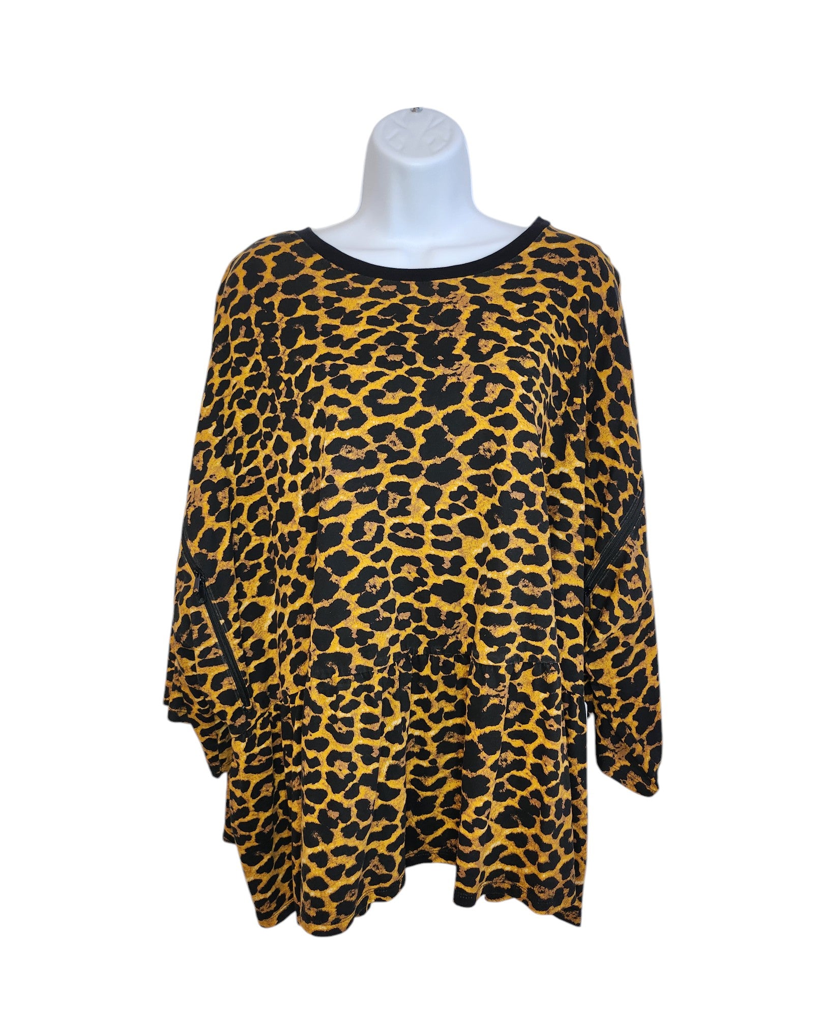 The Upcycled Breastfeeding & Pumping Cheetah T-shirt from touched out mama is a UK30 long-sleeve, loose-fitting blouse with a bold leopard print. Made from preloved clothing, it features a golden yellow base with black spots and neckline trim, merging eco-friendliness with style.