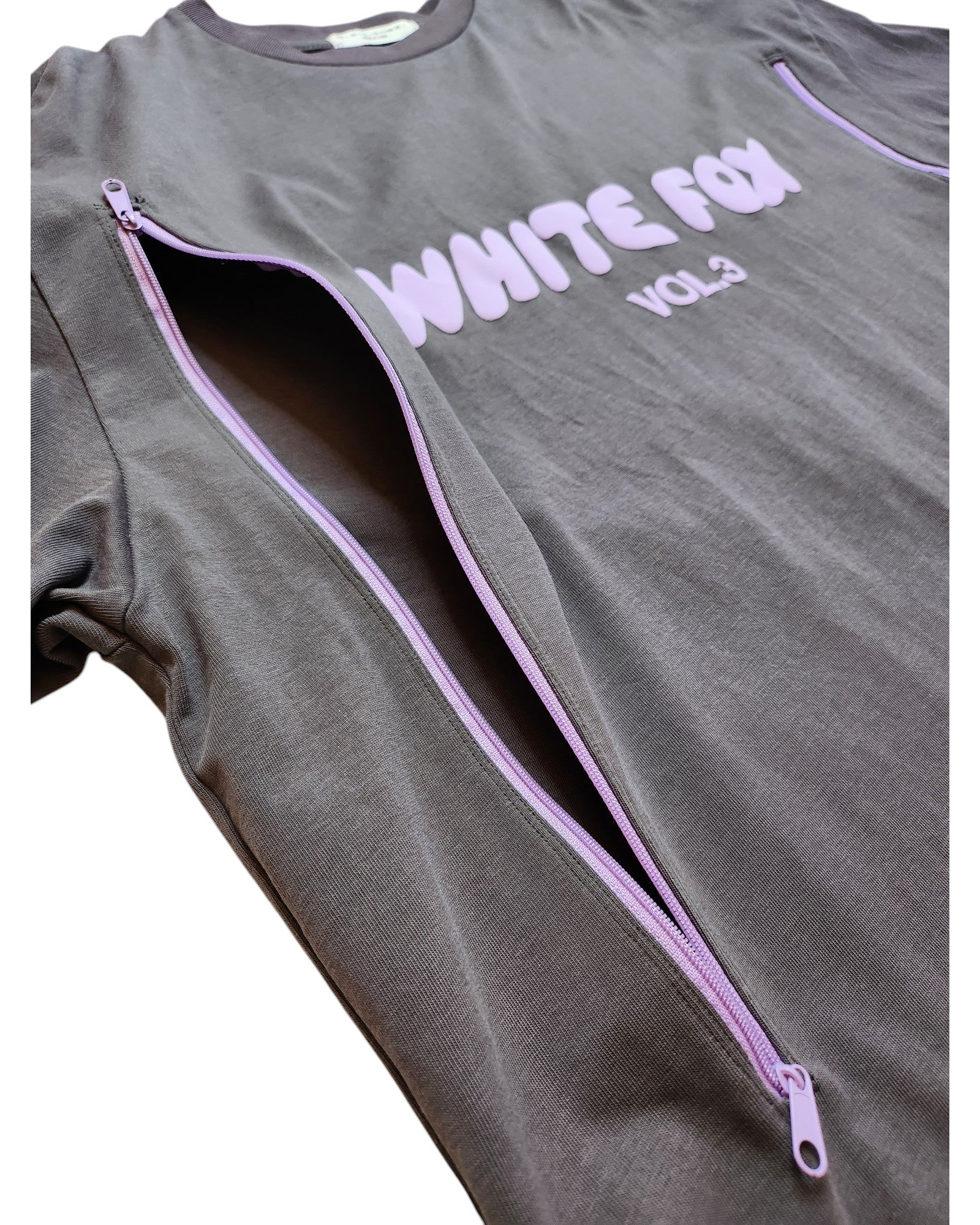The upcycled White Fox Vol.3 t-shirt by touched out mama features lavender zippers down the sides on dark gray fabric, adding style to this preloved breastfeeding and pumping top in size L.