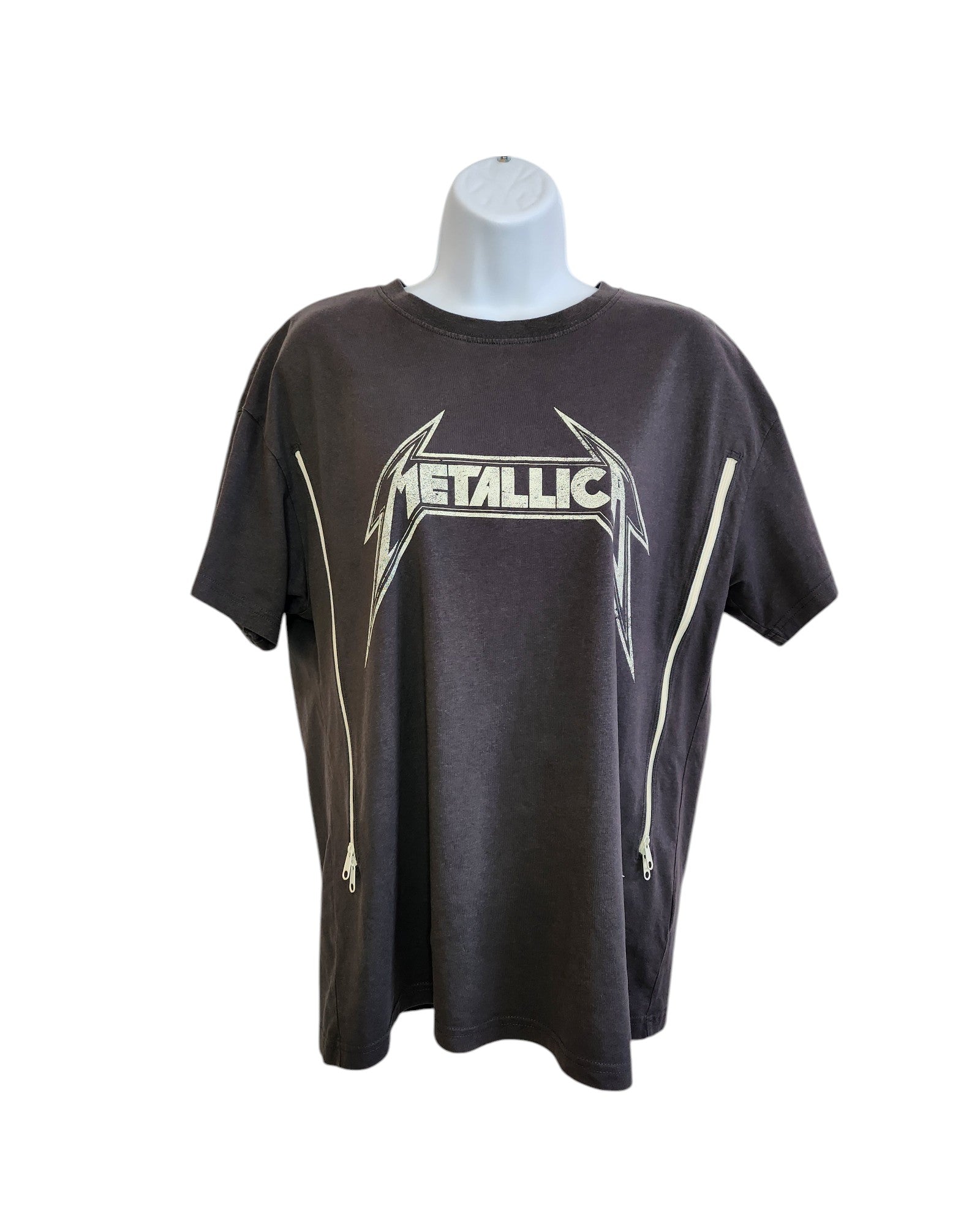 The Upcycled Breastfeeding & Pumping Metallica Grey T-shirt S by touched out mama features a bold logo and side zippers, displayed on a white mannequin torso against a plain background, merging edgy style with sustainable fashion.