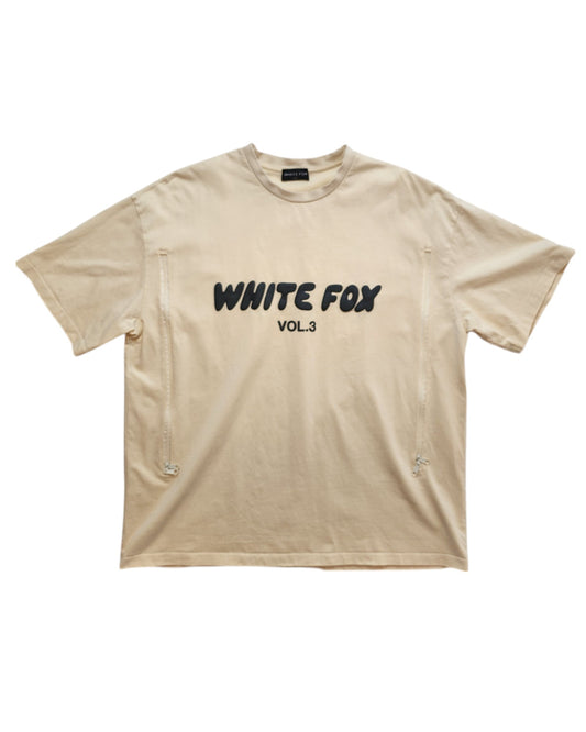 The touched out mama Upcycled Breastfeeding (Nursing) & Pumping White Fox Cream t-shirt M/L offers a casual, loose fit and eco-friendly design. It features an eye-catching WHITE FOX VOL. 3 print in black on beige, highlighting style and sustainability for new mothers.