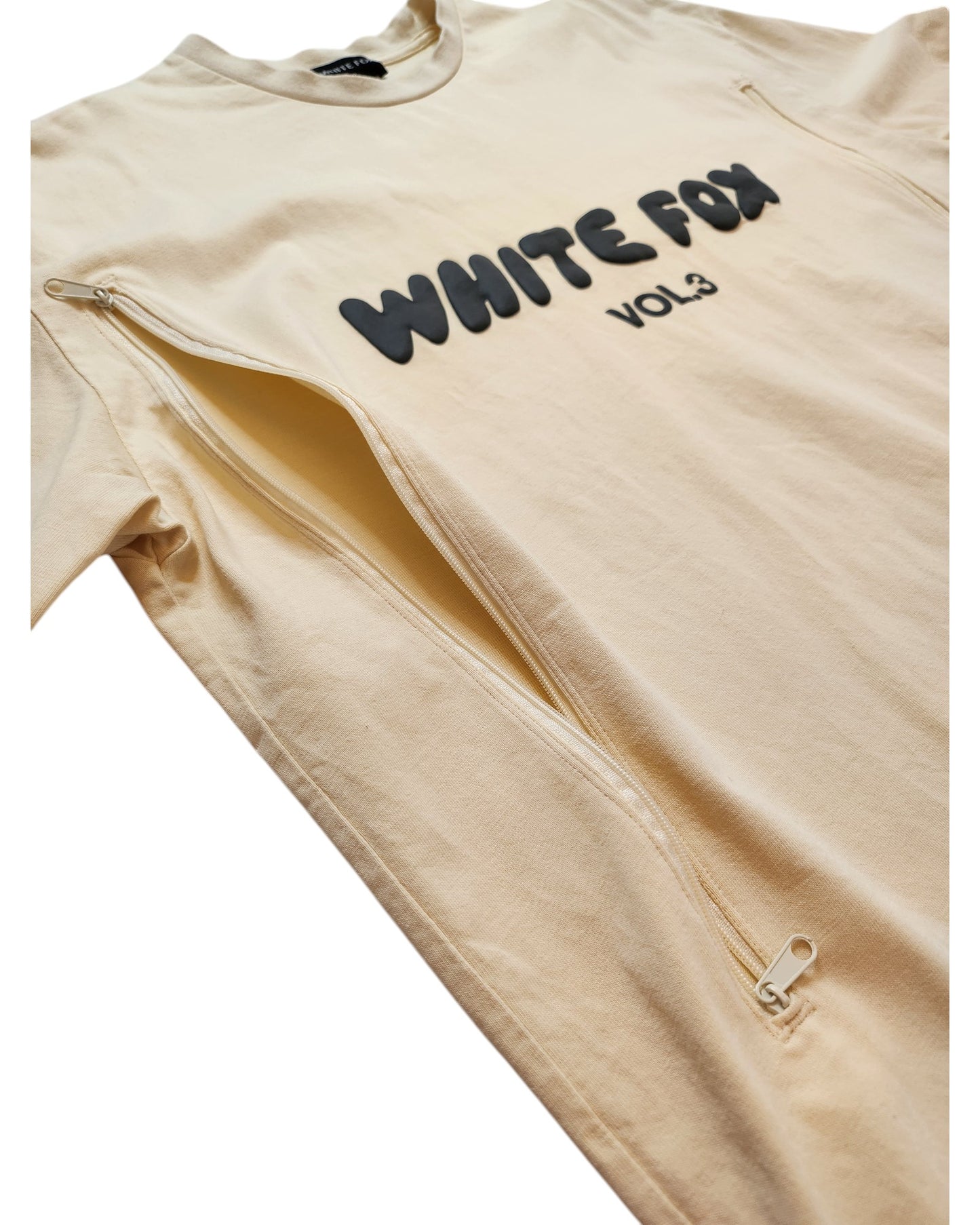 The Upcycled Breastfeeding & Pumping White Fox Cream t-shirt by touched out mama (size M/L) cleverly combines style and practicality, featuring WHITE FOX VOL3 in bold black letters and two vertical zippers on the sides for easy access, revealing inner fabric when partially open.