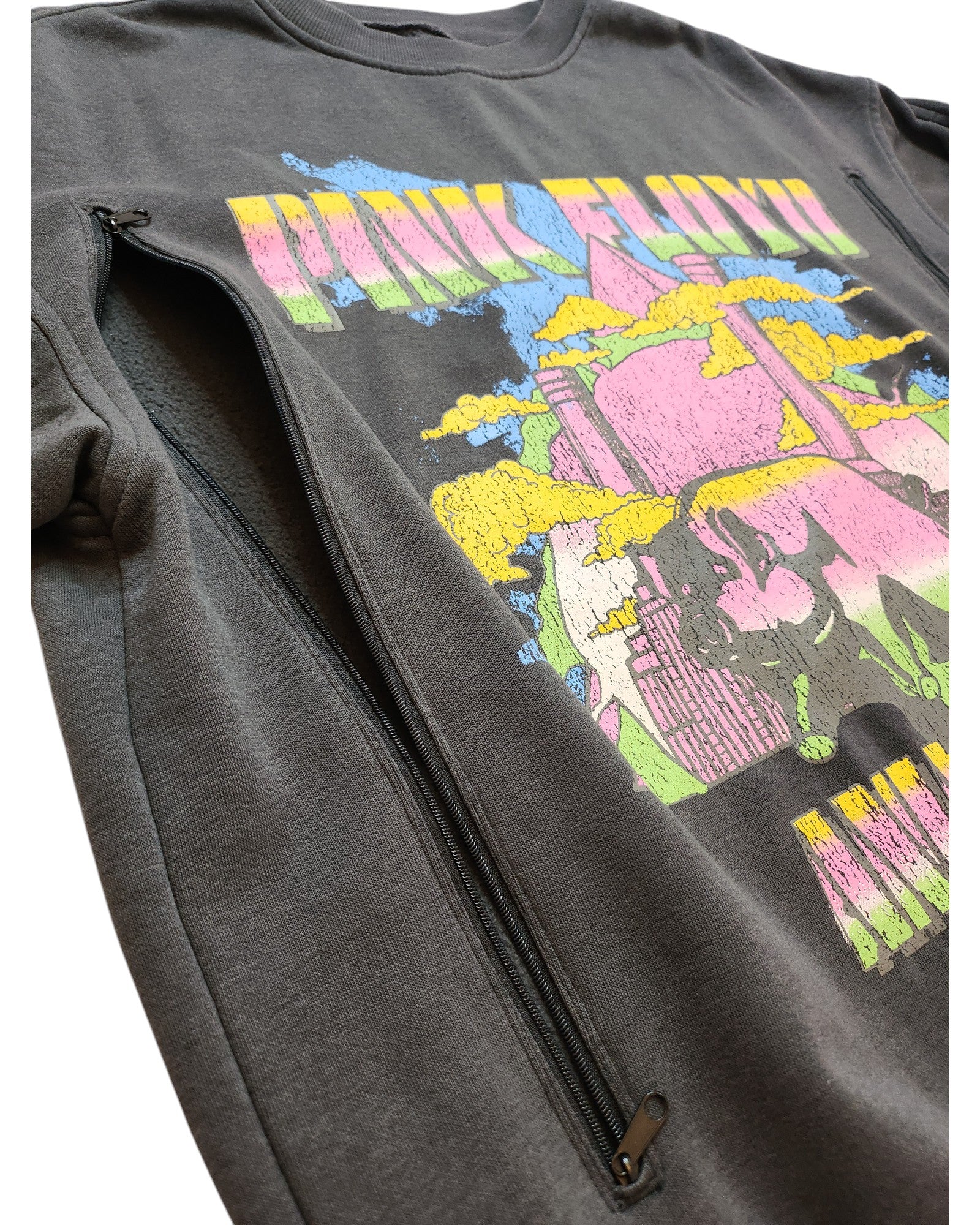 The touched out mama Upcycled Breastfeeding & Pumping Pink Floyd Long-line Sweatshirt S features a vibrant futuristic city graphic in pink, yellow, and blue on dark fabric, crafted from upcycled materials. This sustainable piece comes with convenient side zippers.