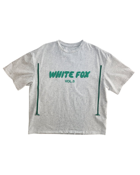 The touched out mamas Upcycled Breastfeeding & Pumping White Fox Grey T-shirt M features a green WHITE FOX VOL. 3 print and two vertical green stripes from hem to mid-shirt, offering a unique eco-friendly design.