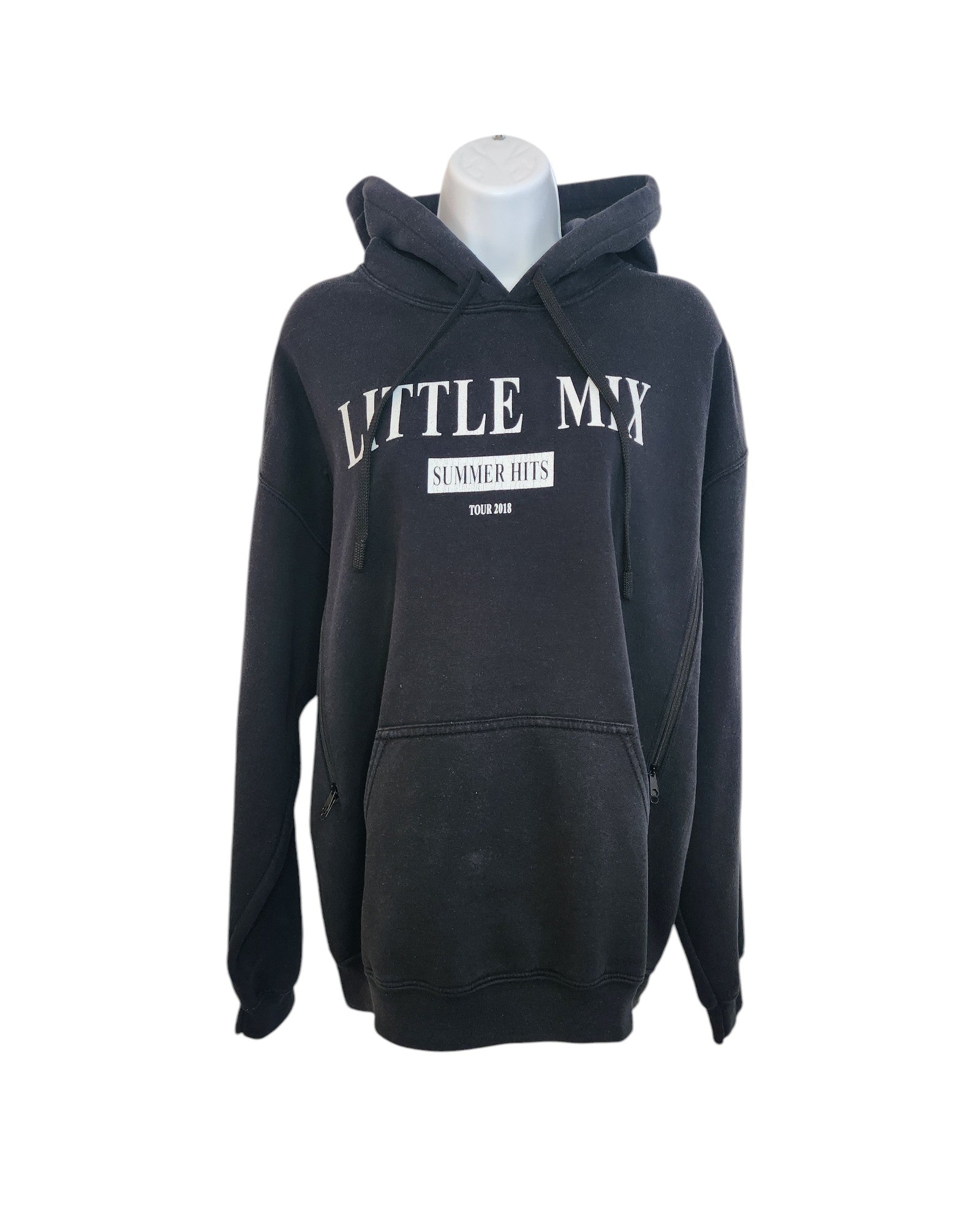 On a mannequin, the upcycled black hoodie by touched out mama features Little Mix Summer Hits Tour 2018 in crisp white, merging sustainable fashion with musical nostalgia.