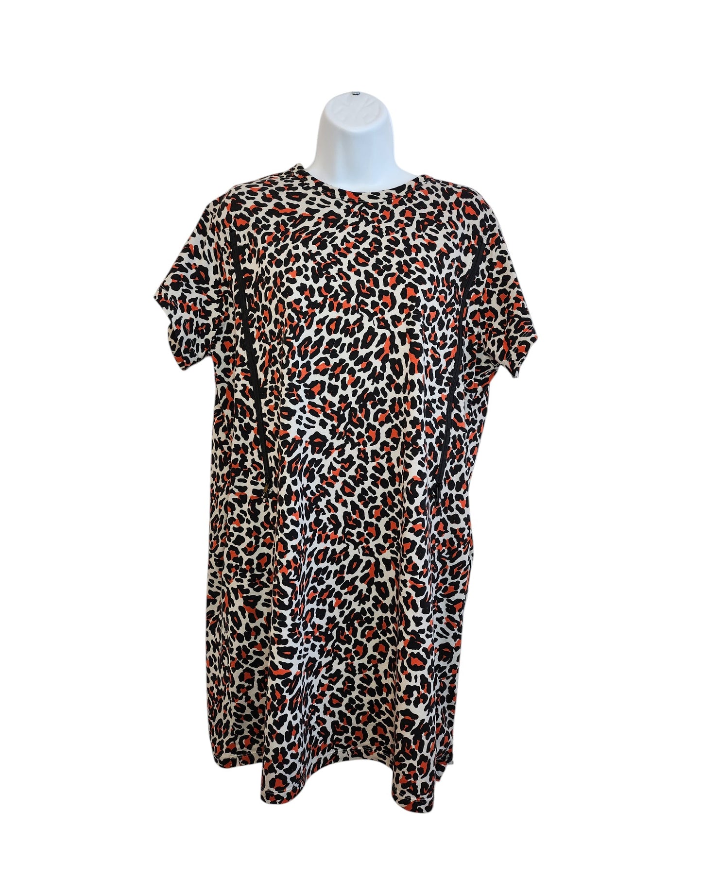 The Upcycled Breastfeeding and Pumping Leopard Pocket T-shirt Dress UK14 from touched out mama, featuring a red, black, and white leopard print on a mannequin torso, offers an eco-friendly knee-length relaxed fit combining style with sustainability.