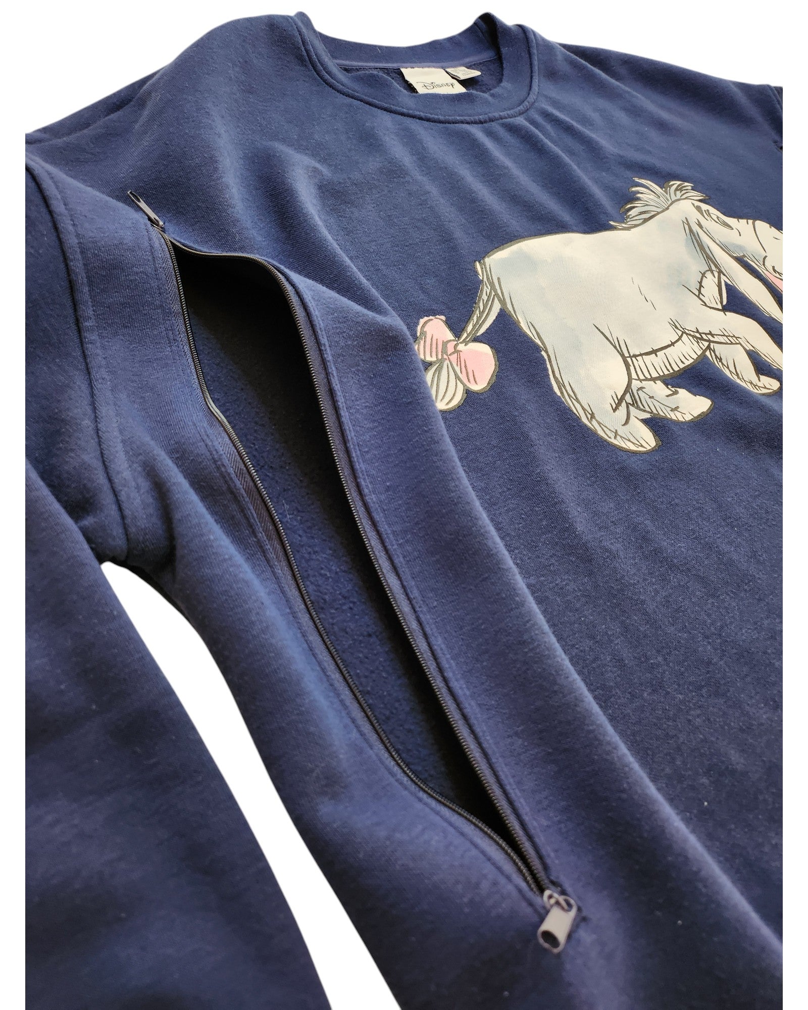 The Primark Upcycled Breastfeeding & Pumping Eeyore Disney Sweatshirt in 2XL is a navy blue eco-friendly sweatshirt with a partial Eeyore illustration and a unique zipper along the left sleeve, perfect for nursing moms.