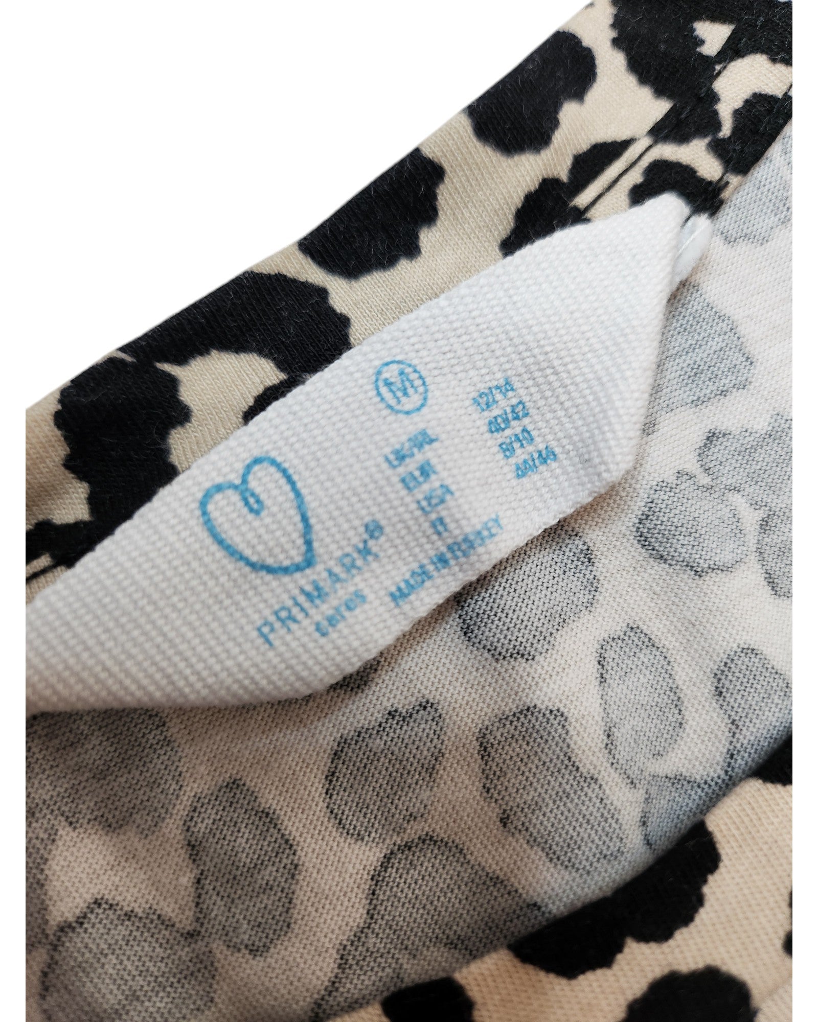 Close-up of a touched out mama label on leopard print fabric. The eco-friendly brands logo, size (L 12/14), fabric composition (92% viscose, 8% elastane), and made in Turkey note are visible.