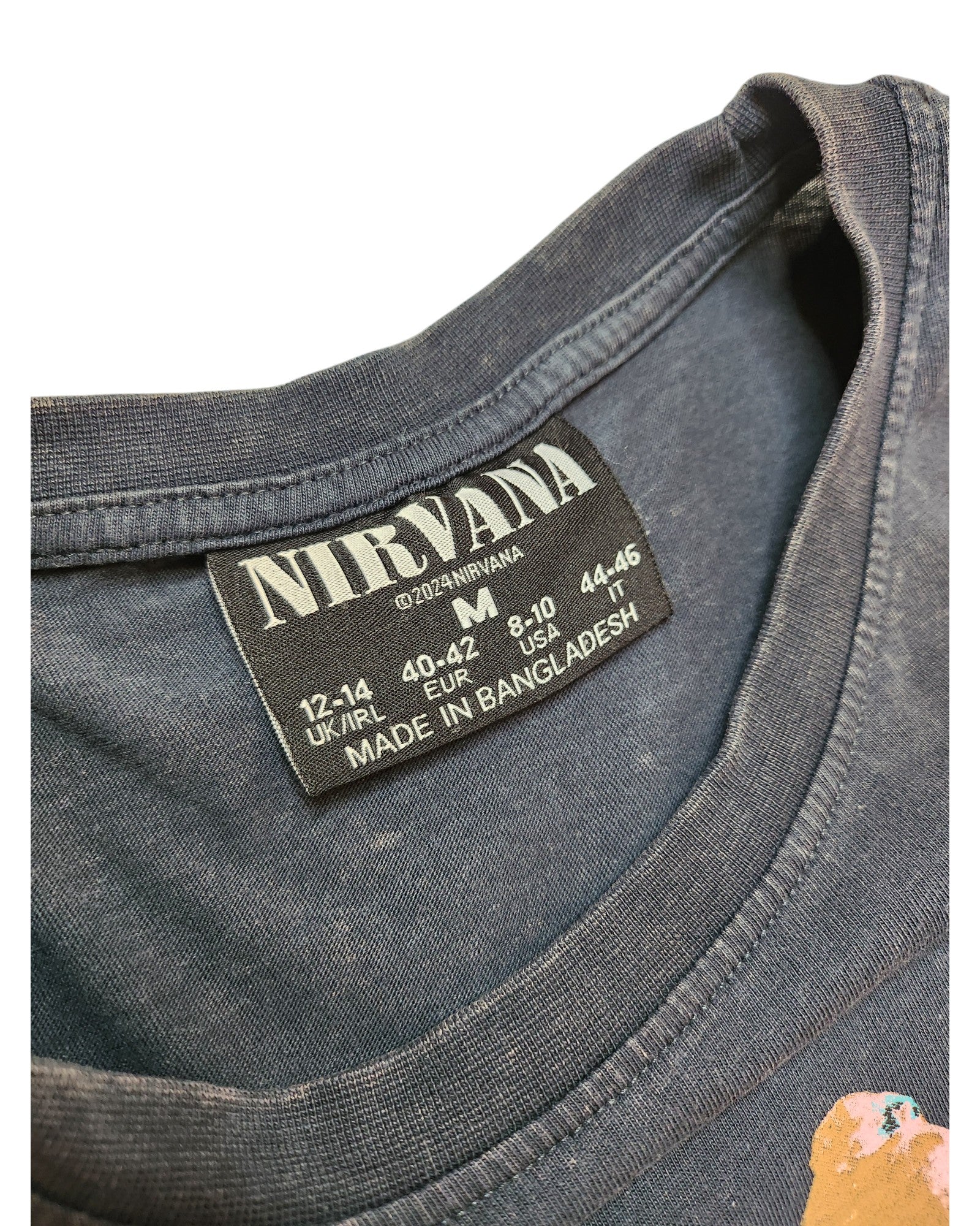 Close-up of a dark gray eco-friendly Upcycled Breastfeeding & Pumping Nirvana Oversized T-shirt M from touched out mama, featuring size info for UK, EUR, and US markets. The sustainable shirt is made in Bangladesh.