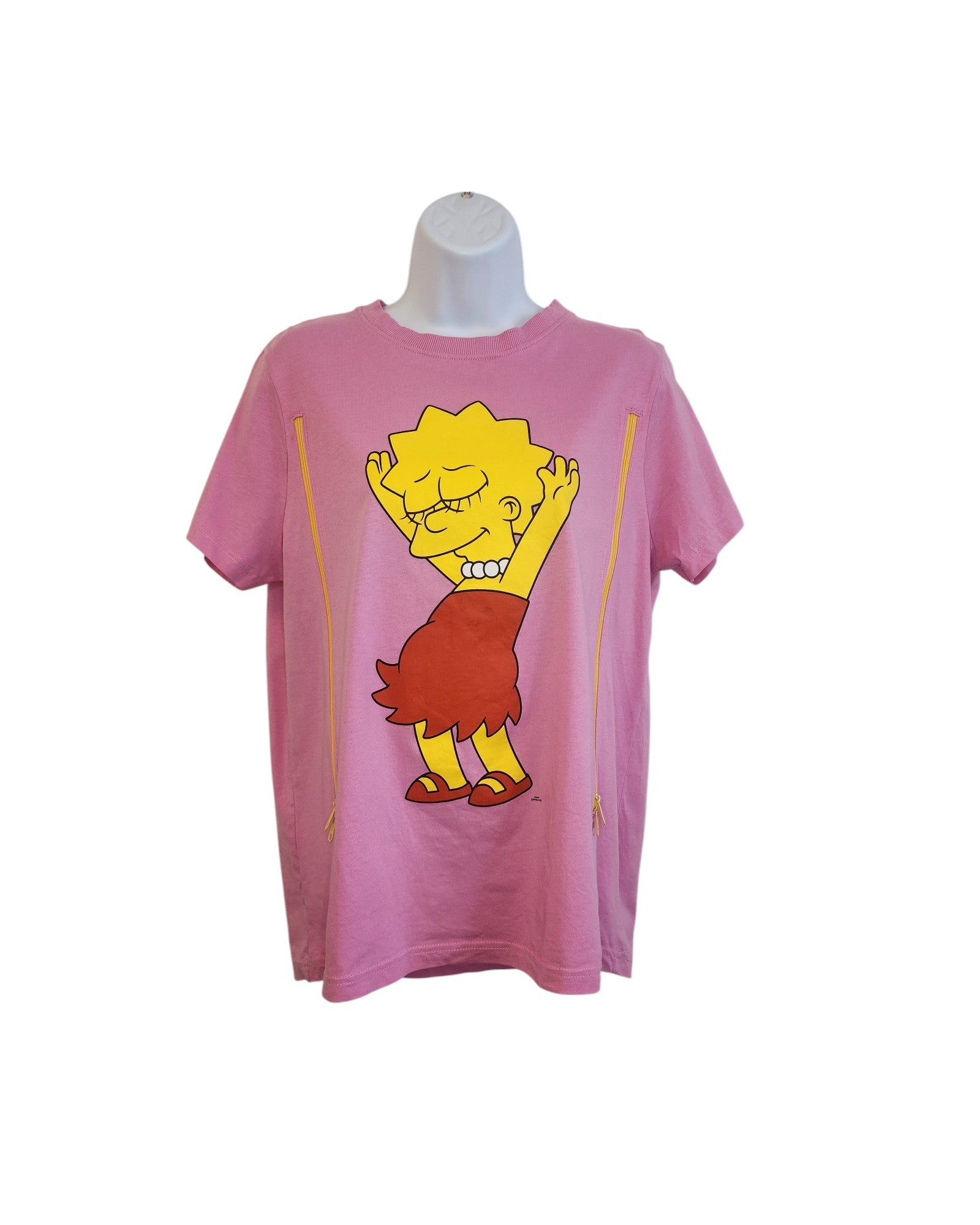 The preloved Upcycled Breastfeeding & Pumping Lisa Simpson T-shirt, sized M, by touched out mama is displayed on a mannequin. It features Lisa in a red dress joyfully raising her arms against a white backdrop, highlighting its charming appeal.