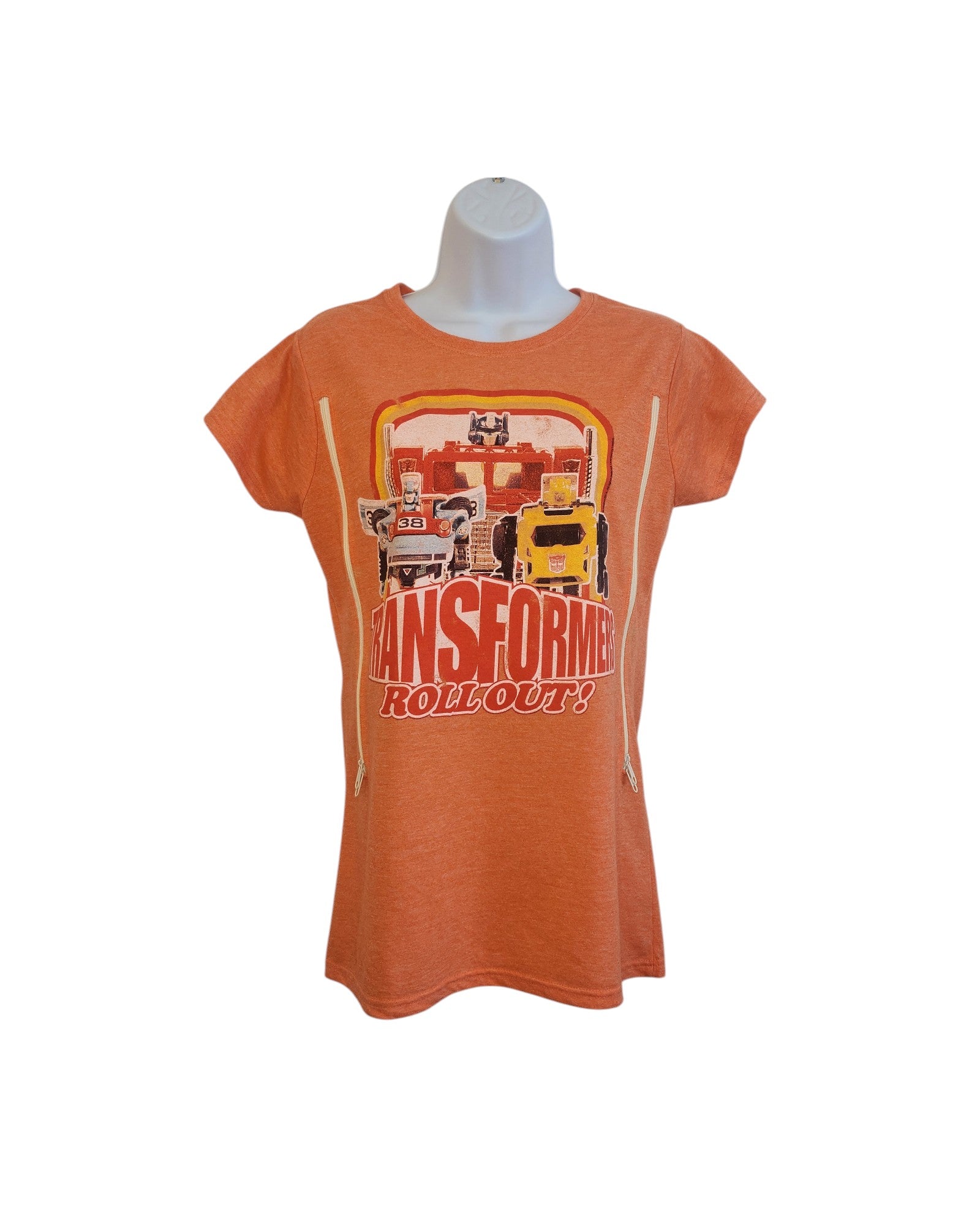 The Truffle Shuffle Upcycled Breastfeeding & Pumping Orange Transformers T-shirt (M) features a front graphic and TRANSFORMERS ROLL OUT! text—a fun, eco-friendly choice for nursing moms.