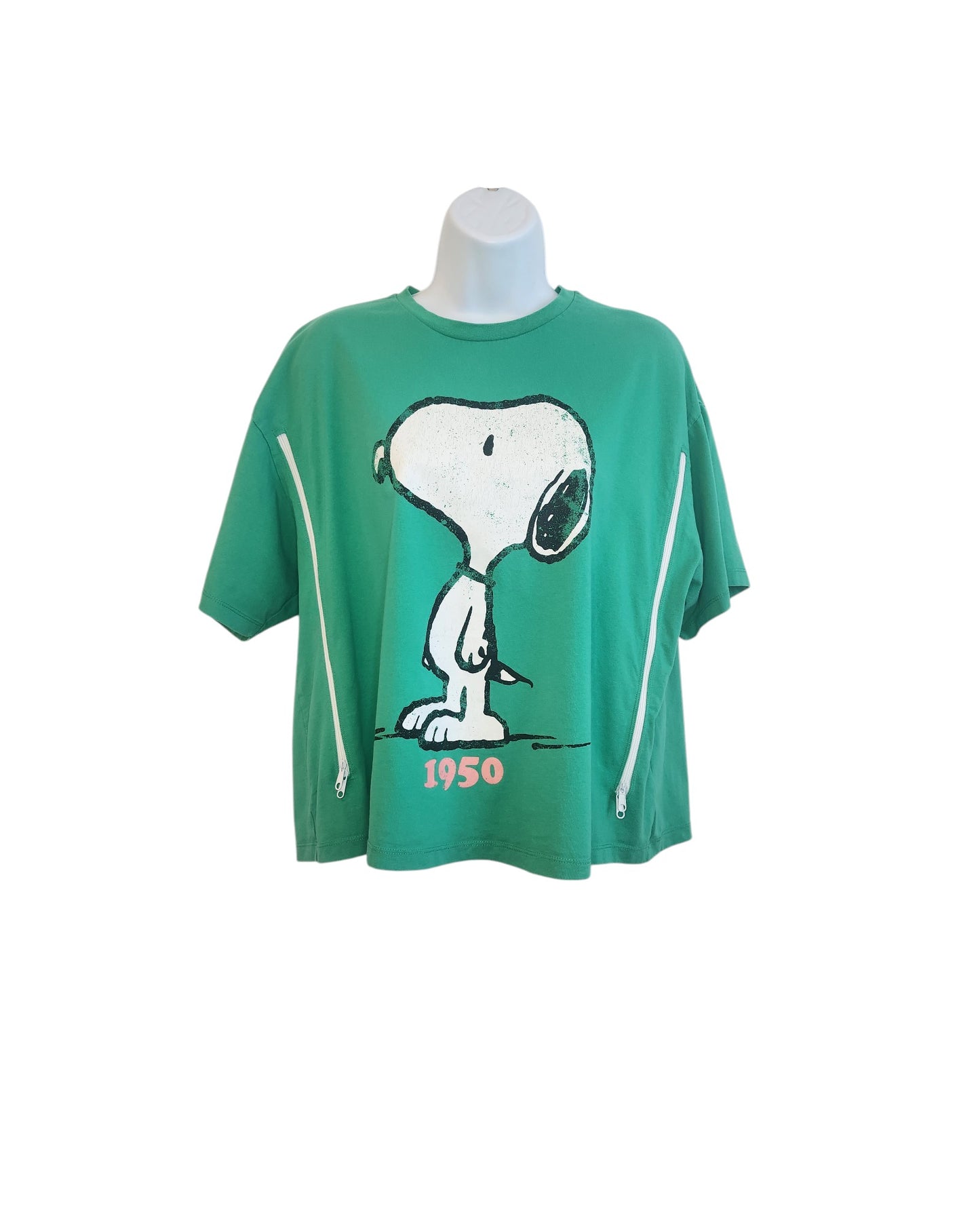 The Upcycled Breastfeeding & Pumping Peanuts Snoopy T-shirt by touched out mama is a green, eco-friendly tee with a cartoon dog design and the year 1950 on the front, featuring two white vertical side zippers, displayed on a white mannequin torso.